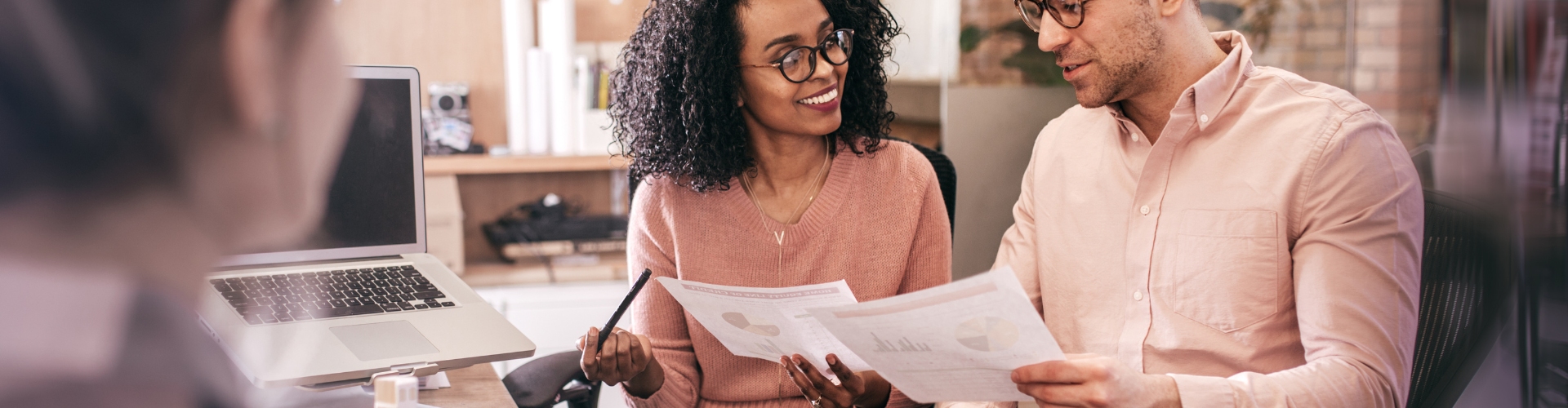 A man and a woman looking at a laptop.