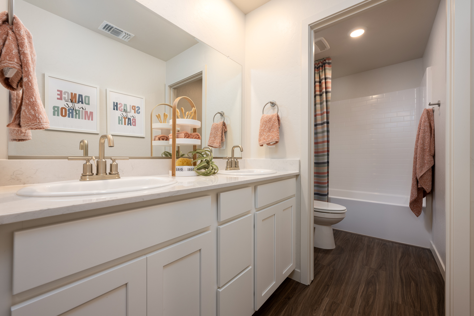 A bathroom with a sink toilet and a shower.