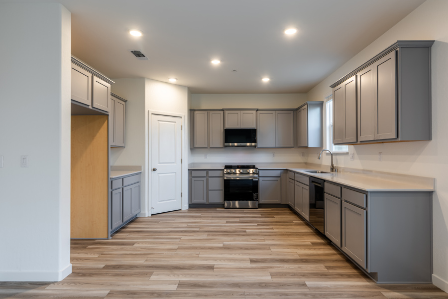 A kitchen with black cabinets.