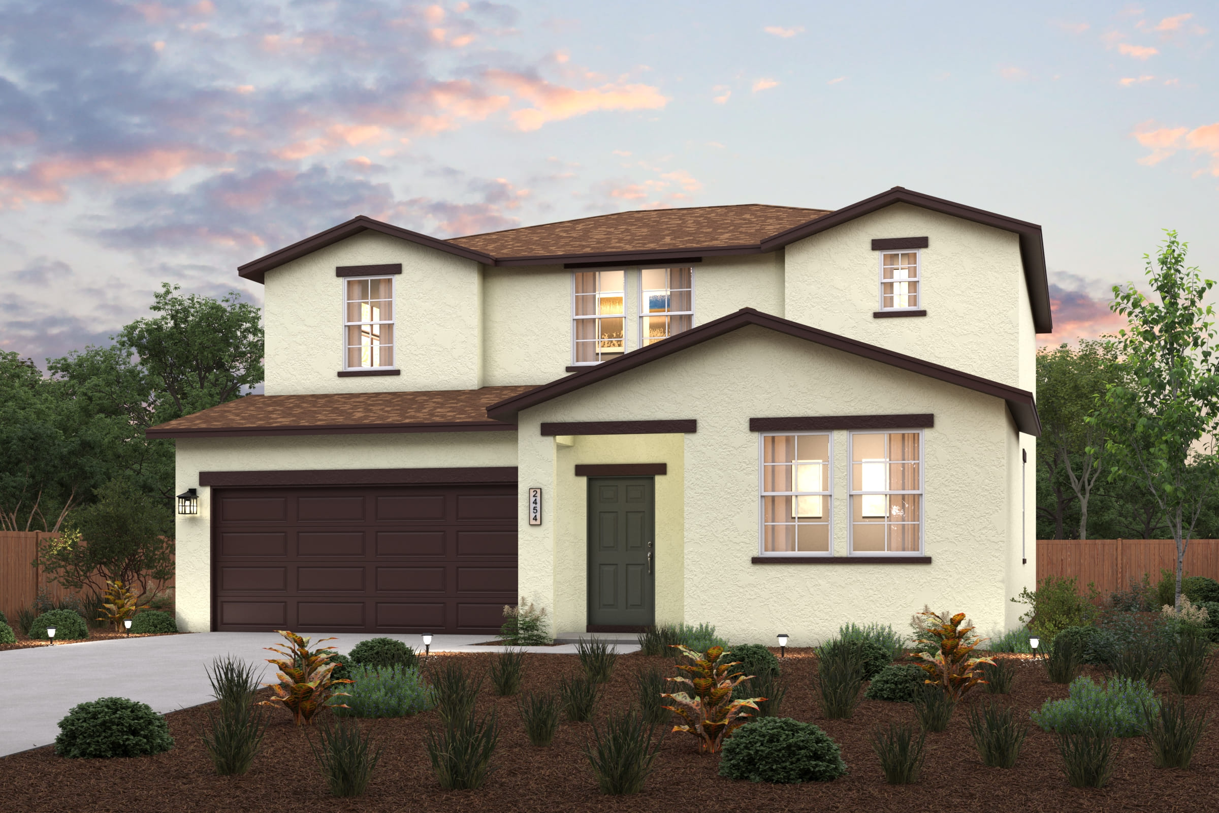 A house with a garage and bushes in front of it.