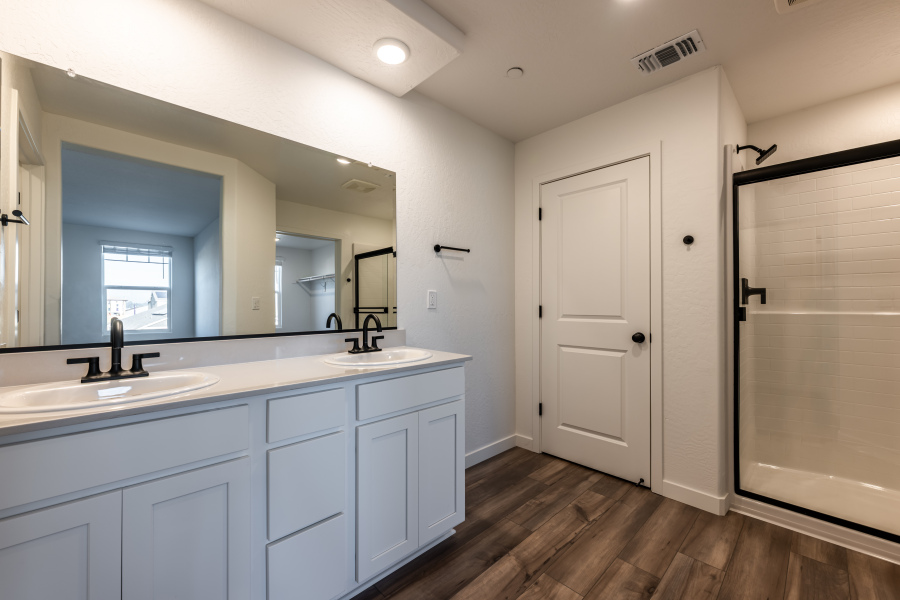 A bathroom with white cabinets.
