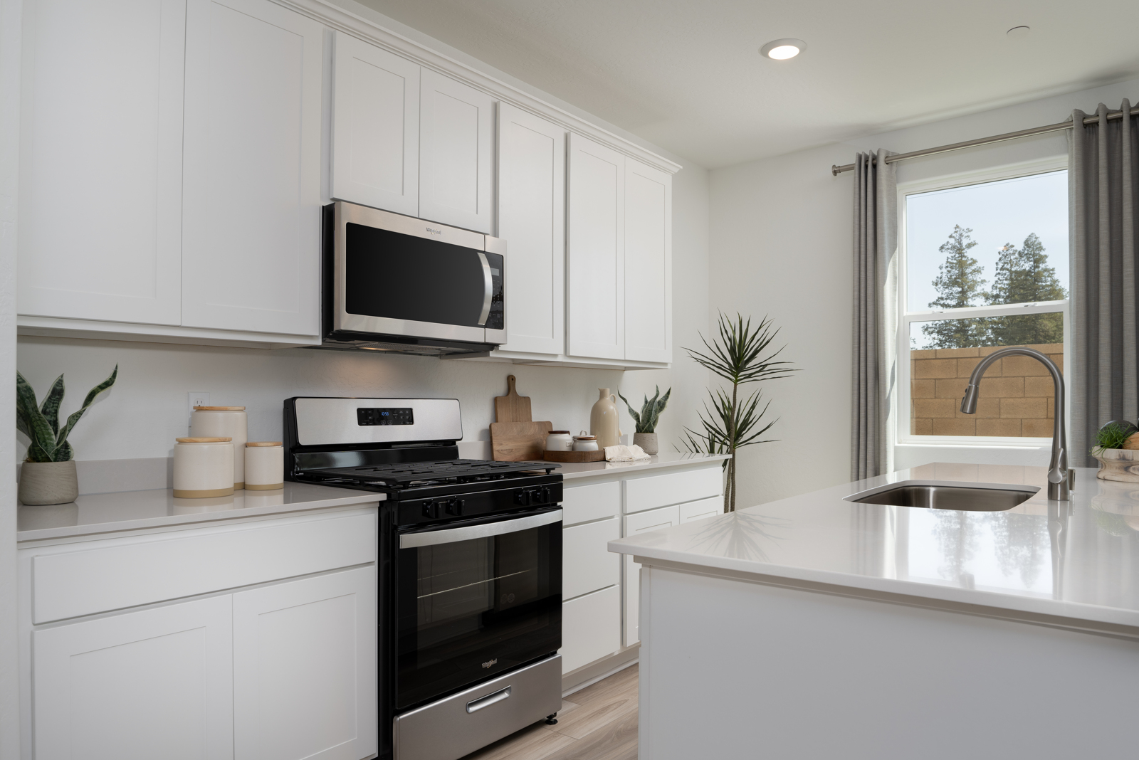 A kitchen with white cabinets.
