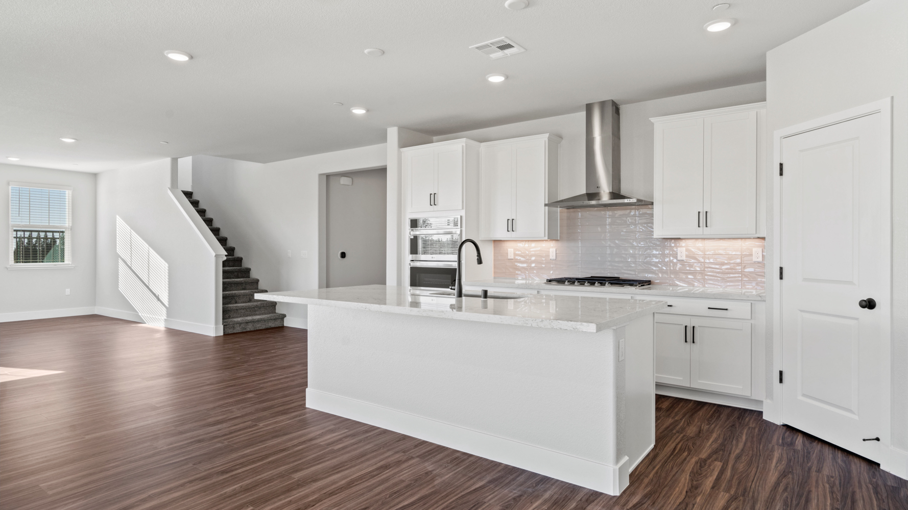 A kitchen with white cabinets.