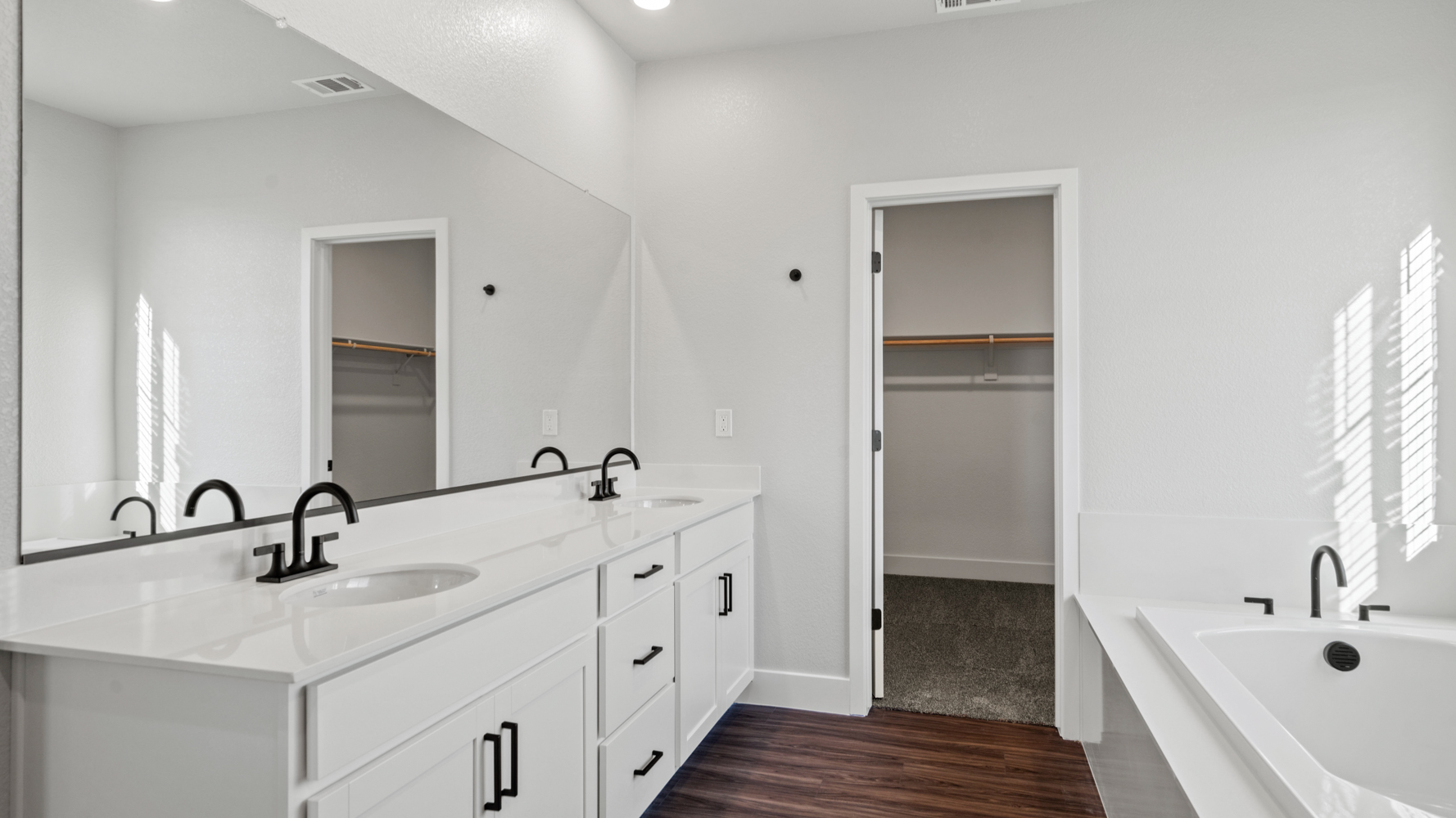 A bathroom with a large mirror.