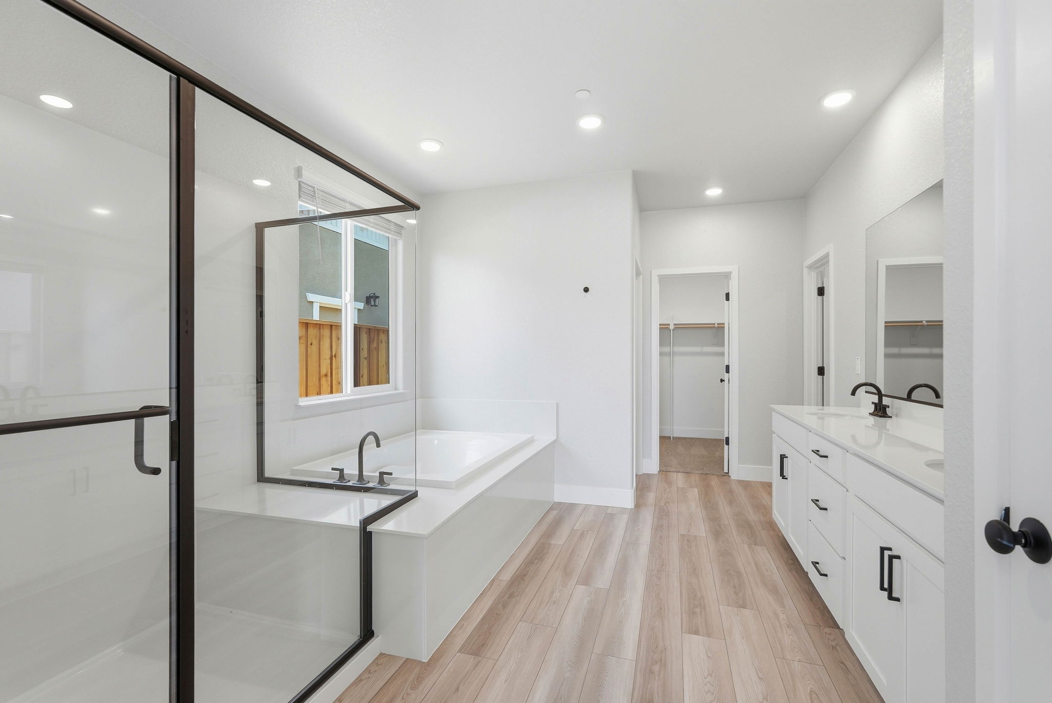 A bathroom with a wood floor.