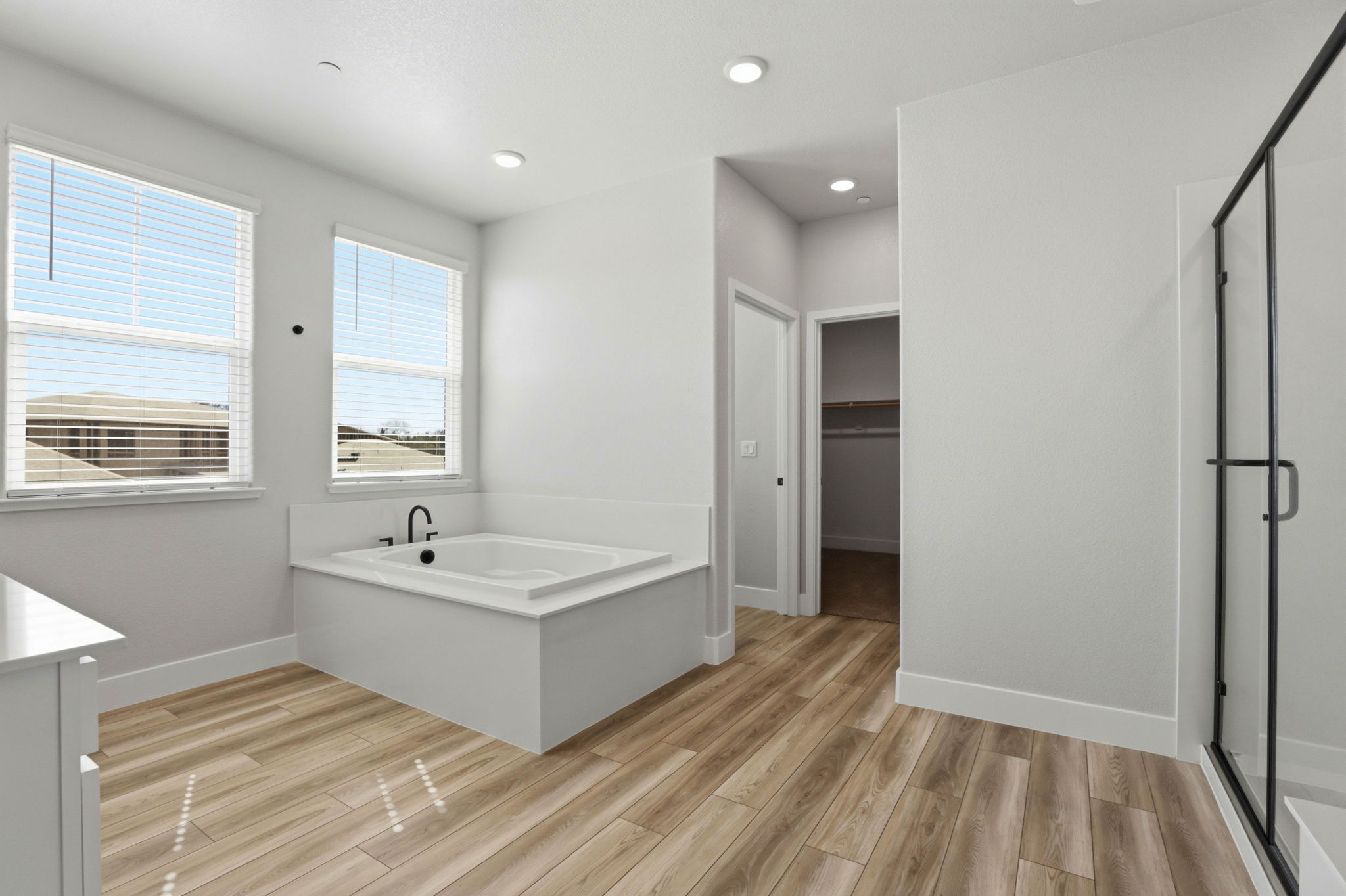 A bathroom with a wood floor.