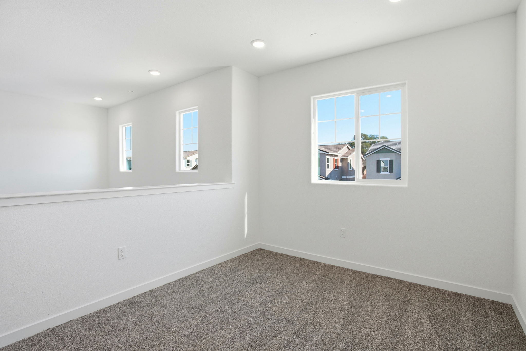 A room with white walls and windows.