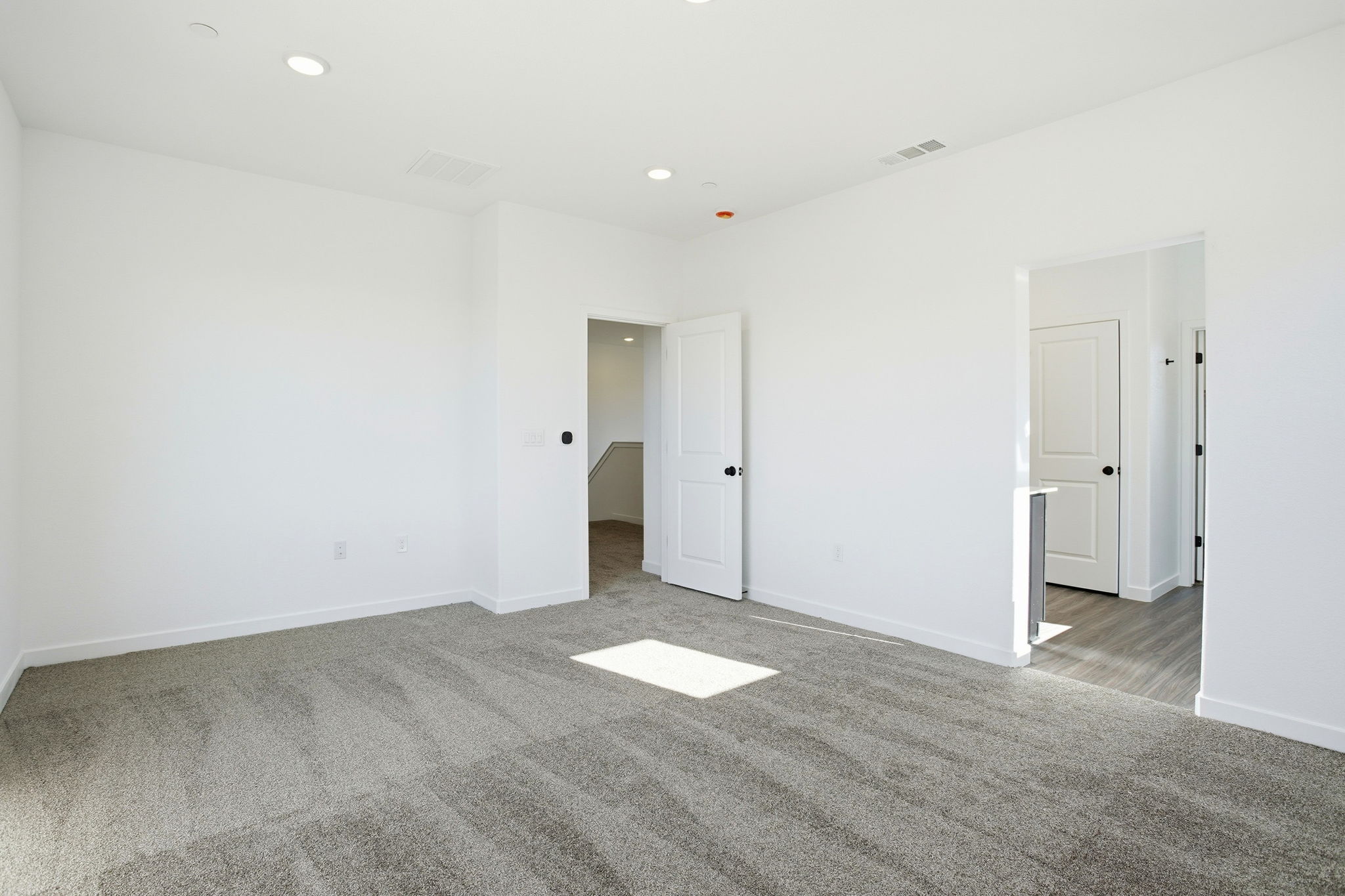 A hallway with white doors.