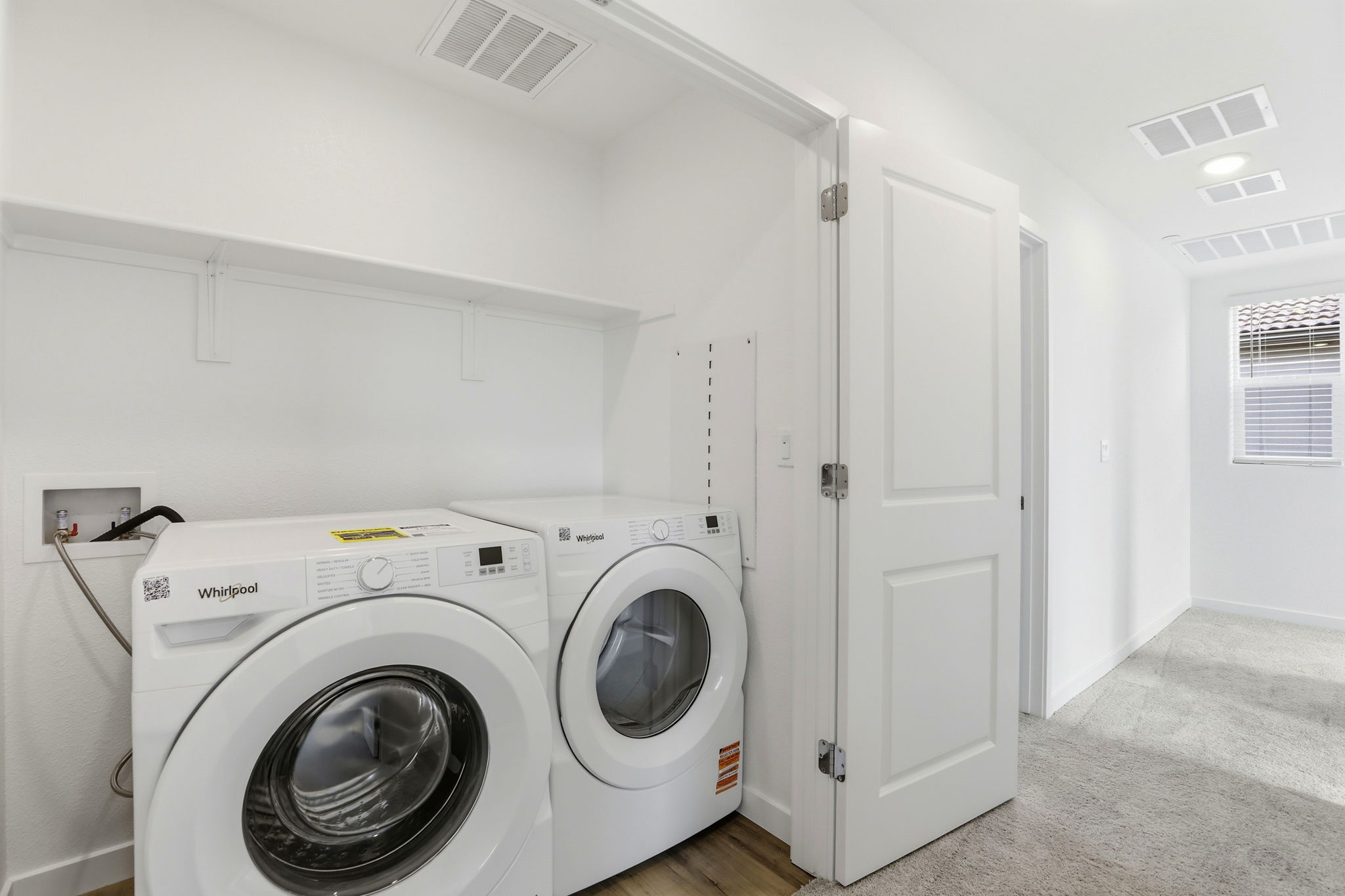 A washing machine in a room.