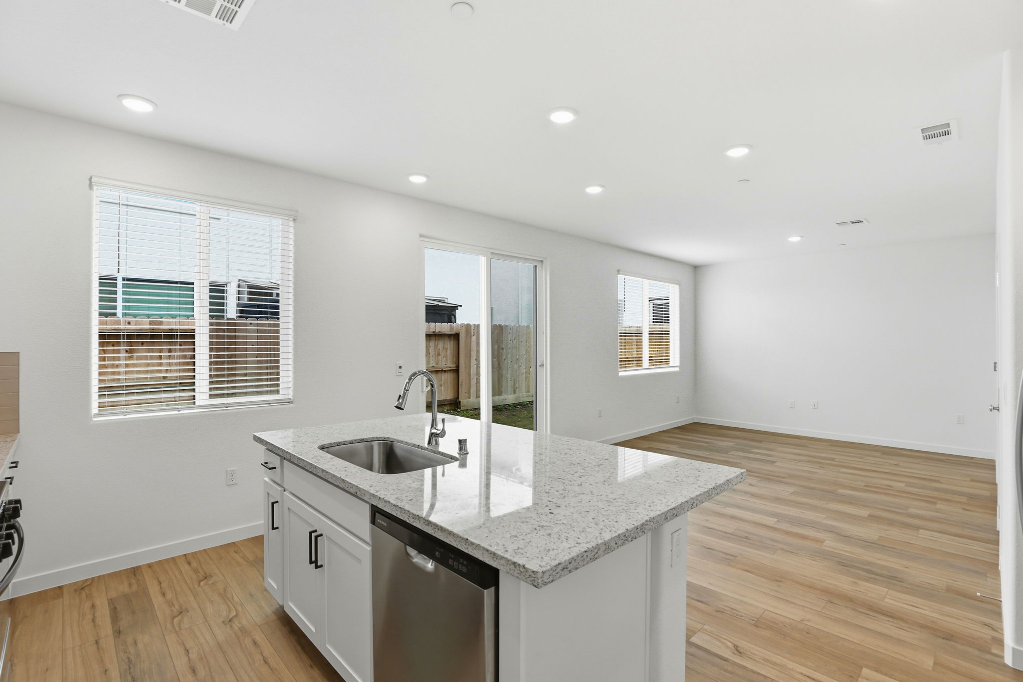 A kitchen with a marble countertop.