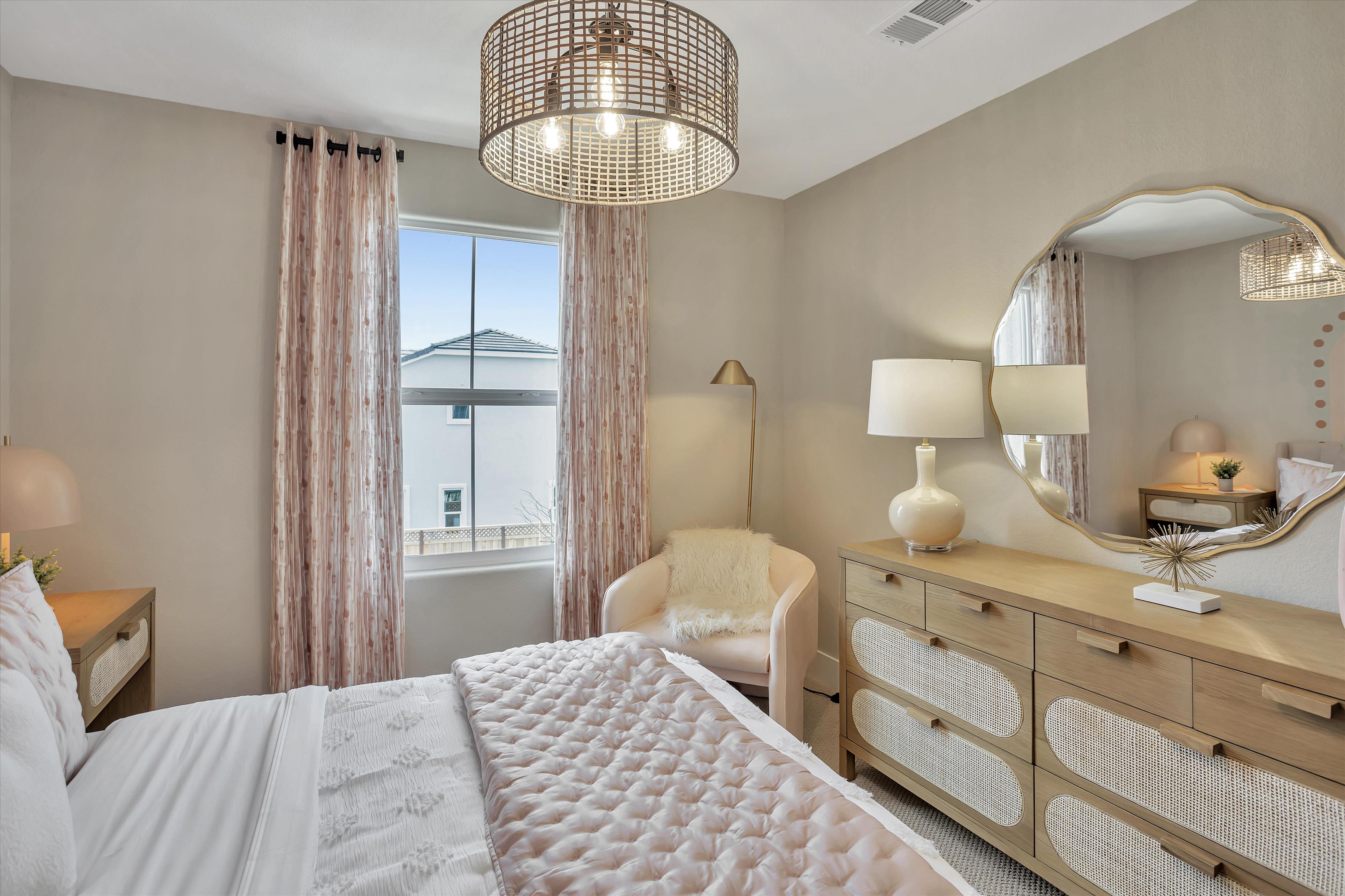 A bedroom with a large window.