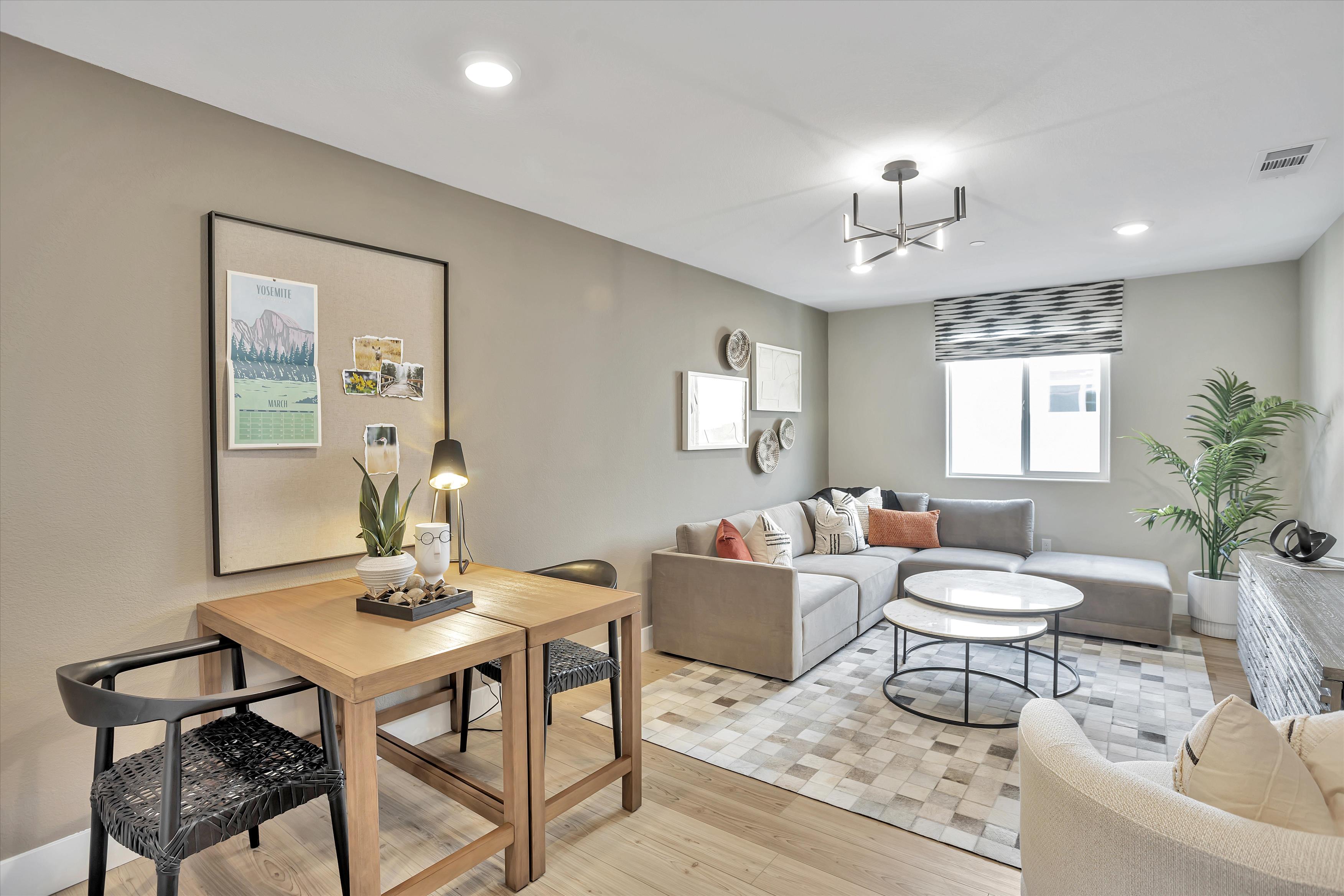 A living room with a table and chairs.