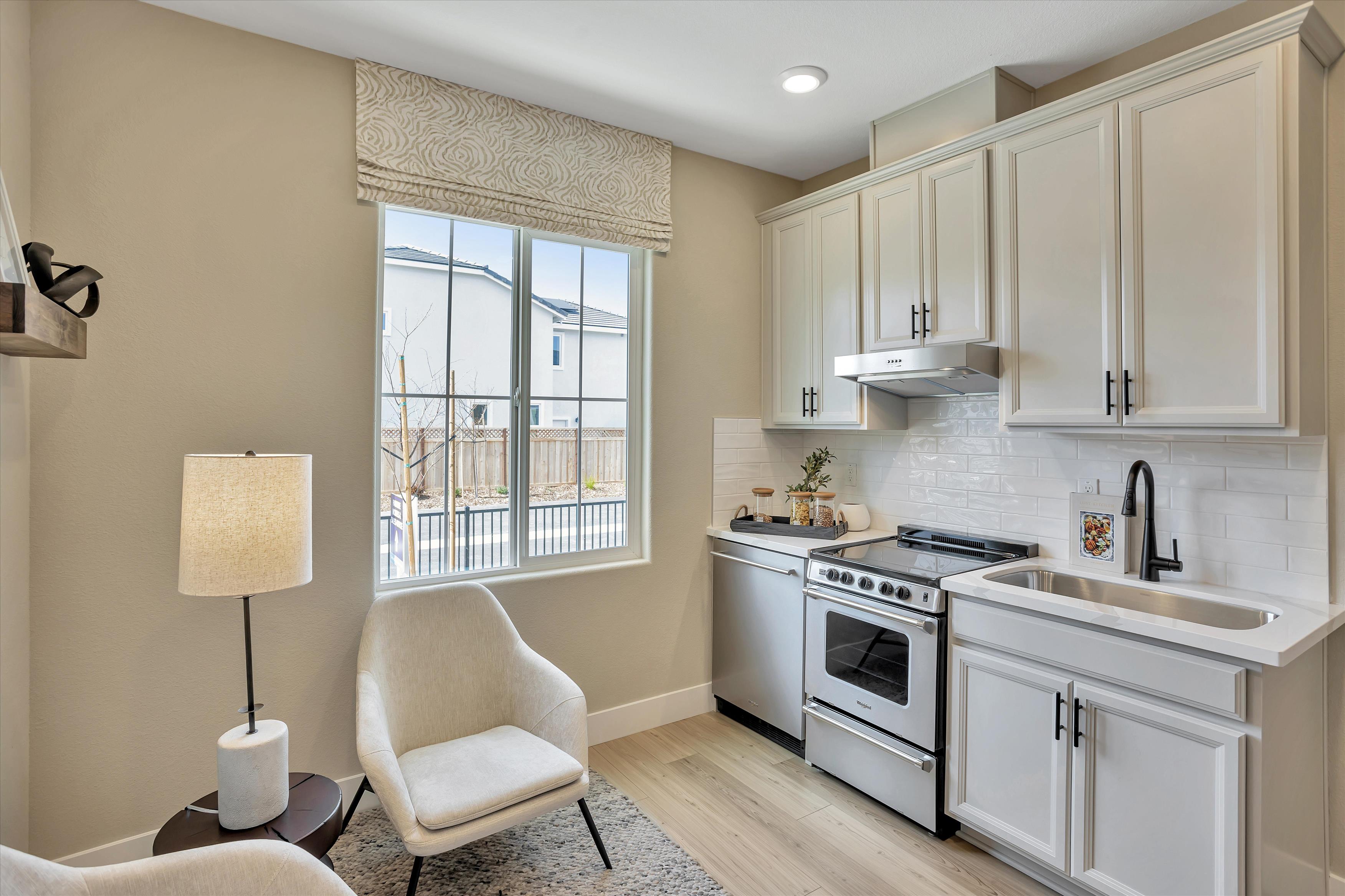 A kitchen with white cabinets.