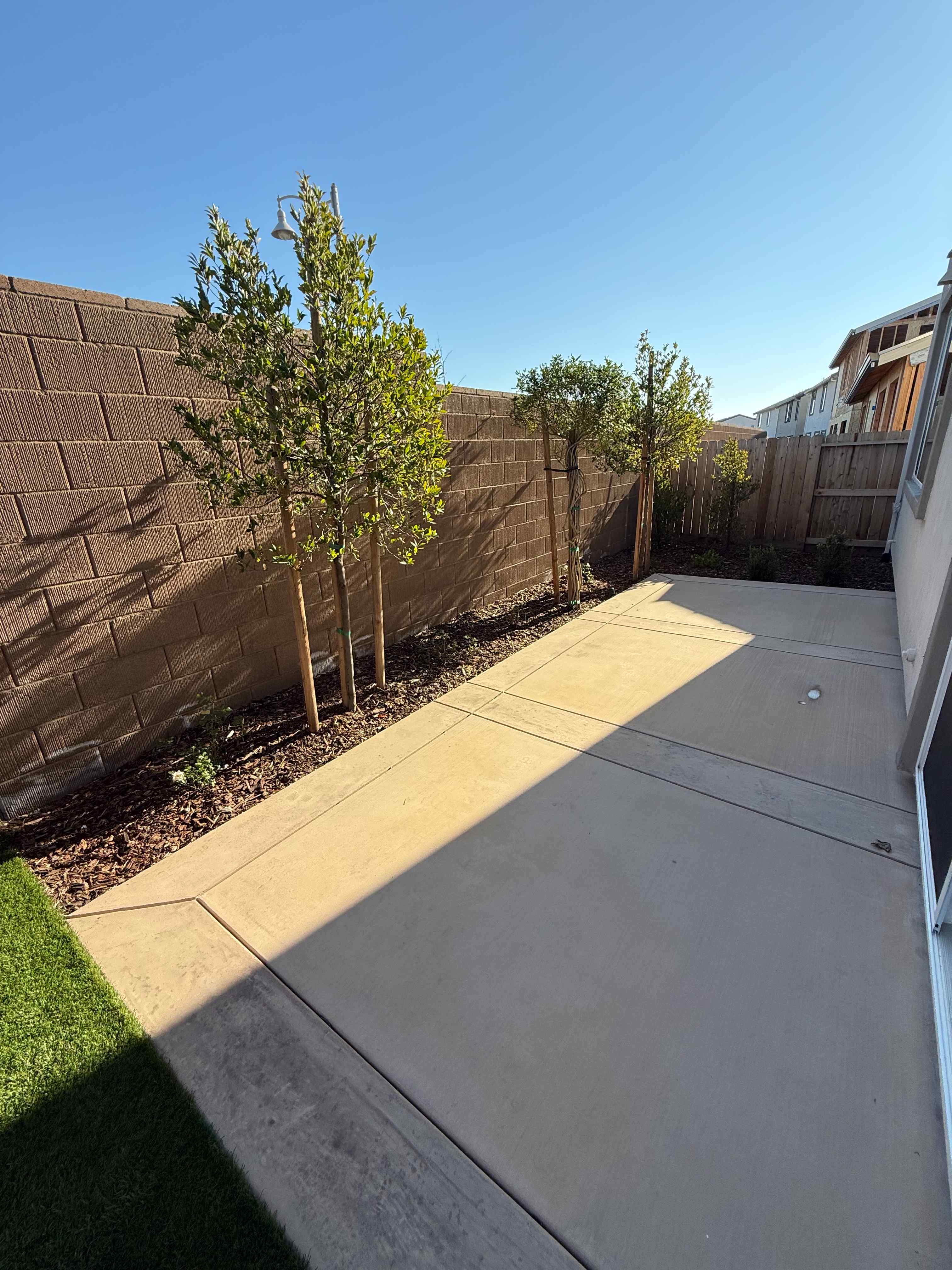 A sidewalk and a fence.