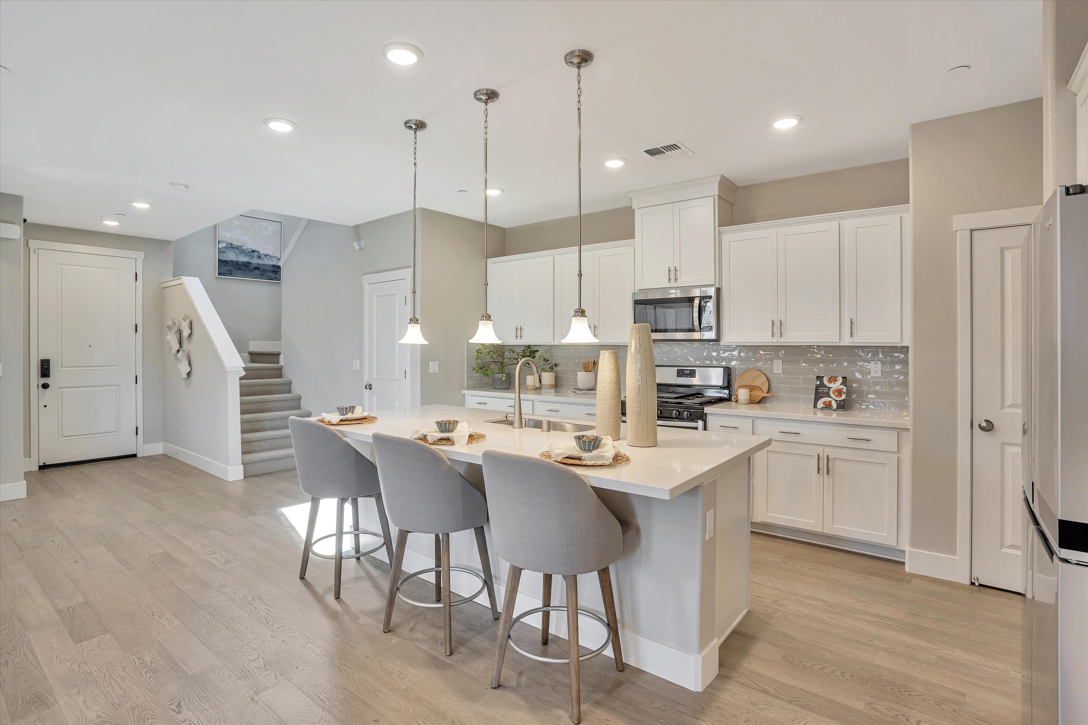 A kitchen with white cabinets.