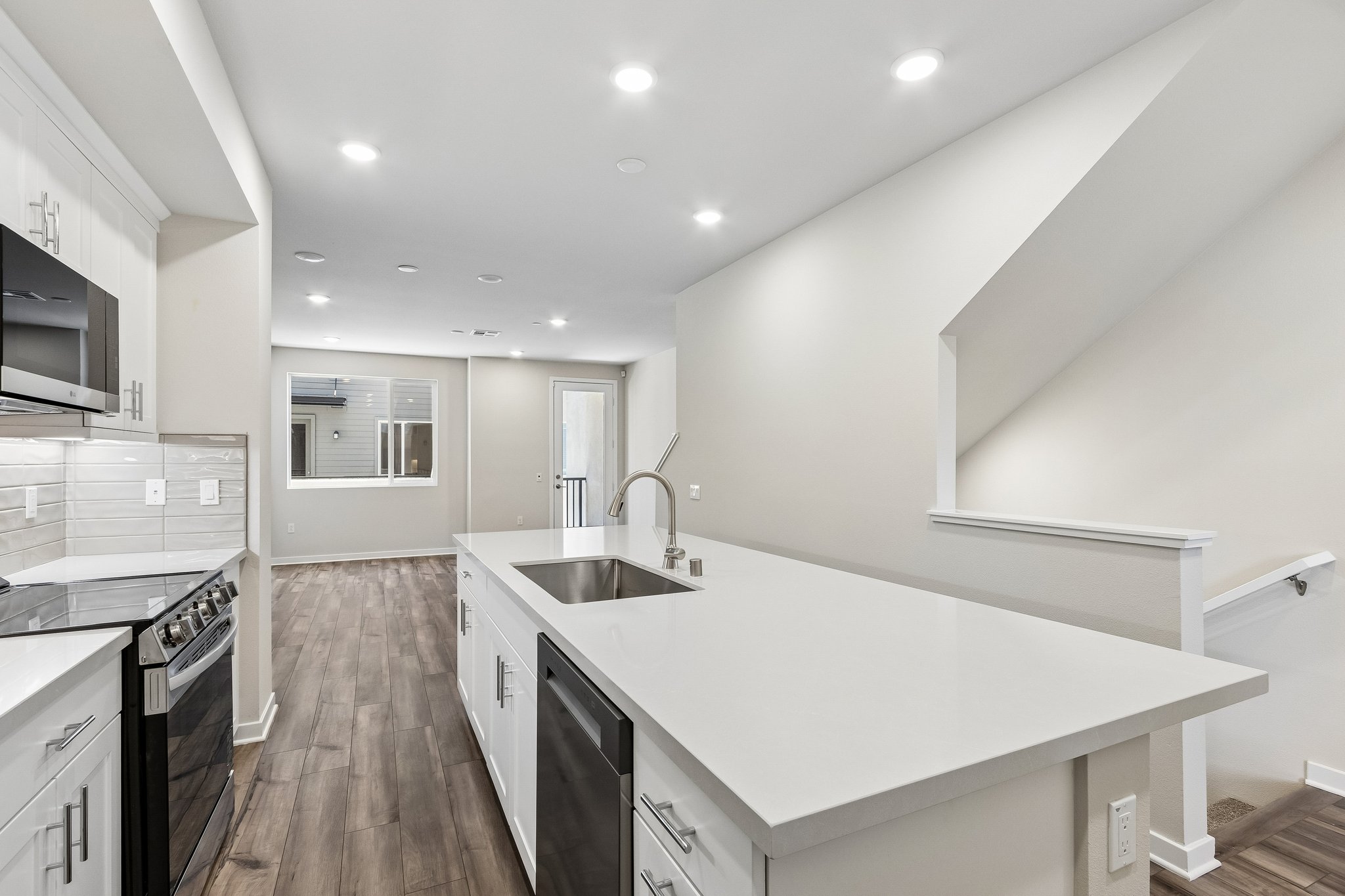 A kitchen with white cabinets.