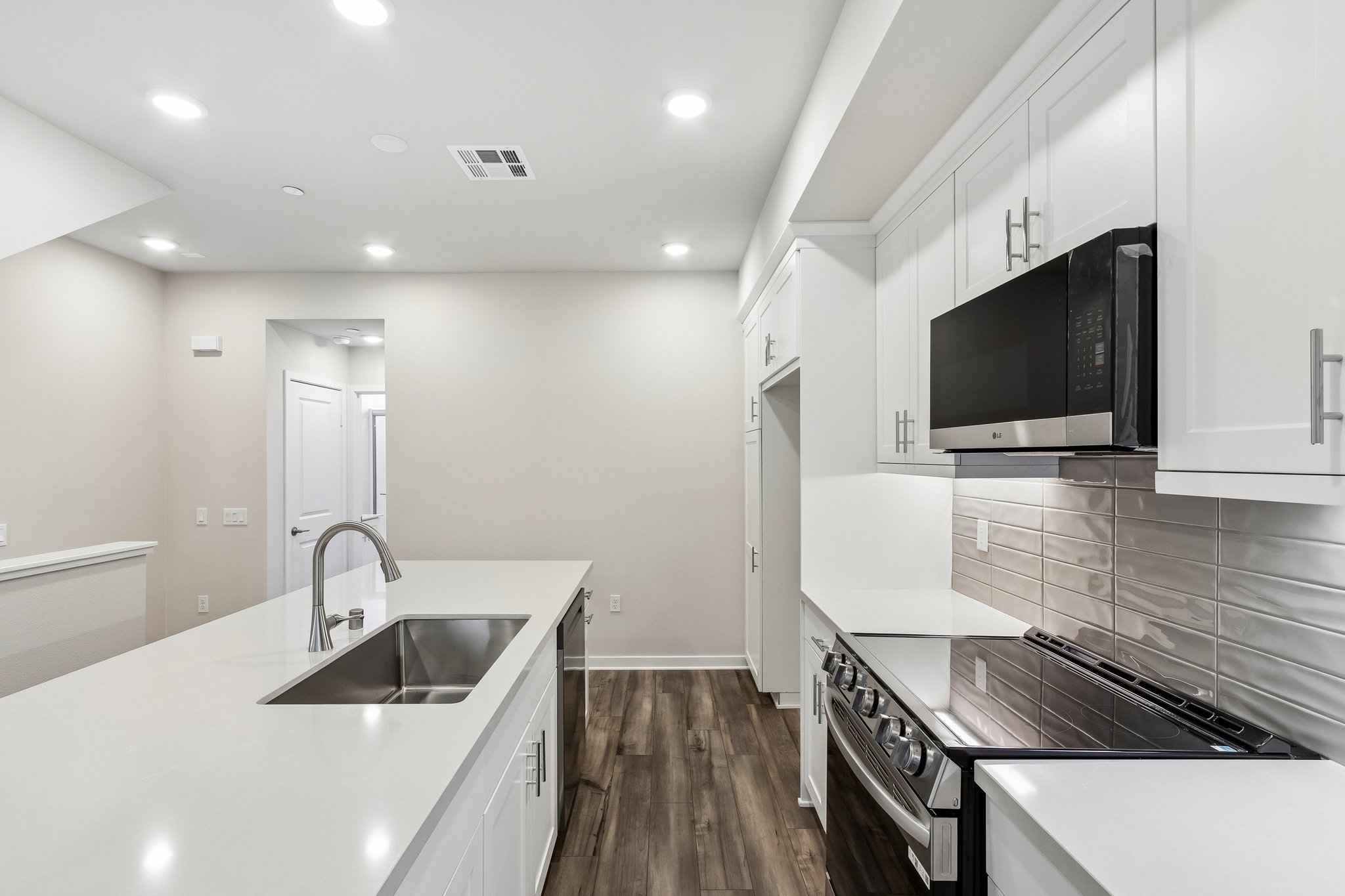 A kitchen with white cabinets.