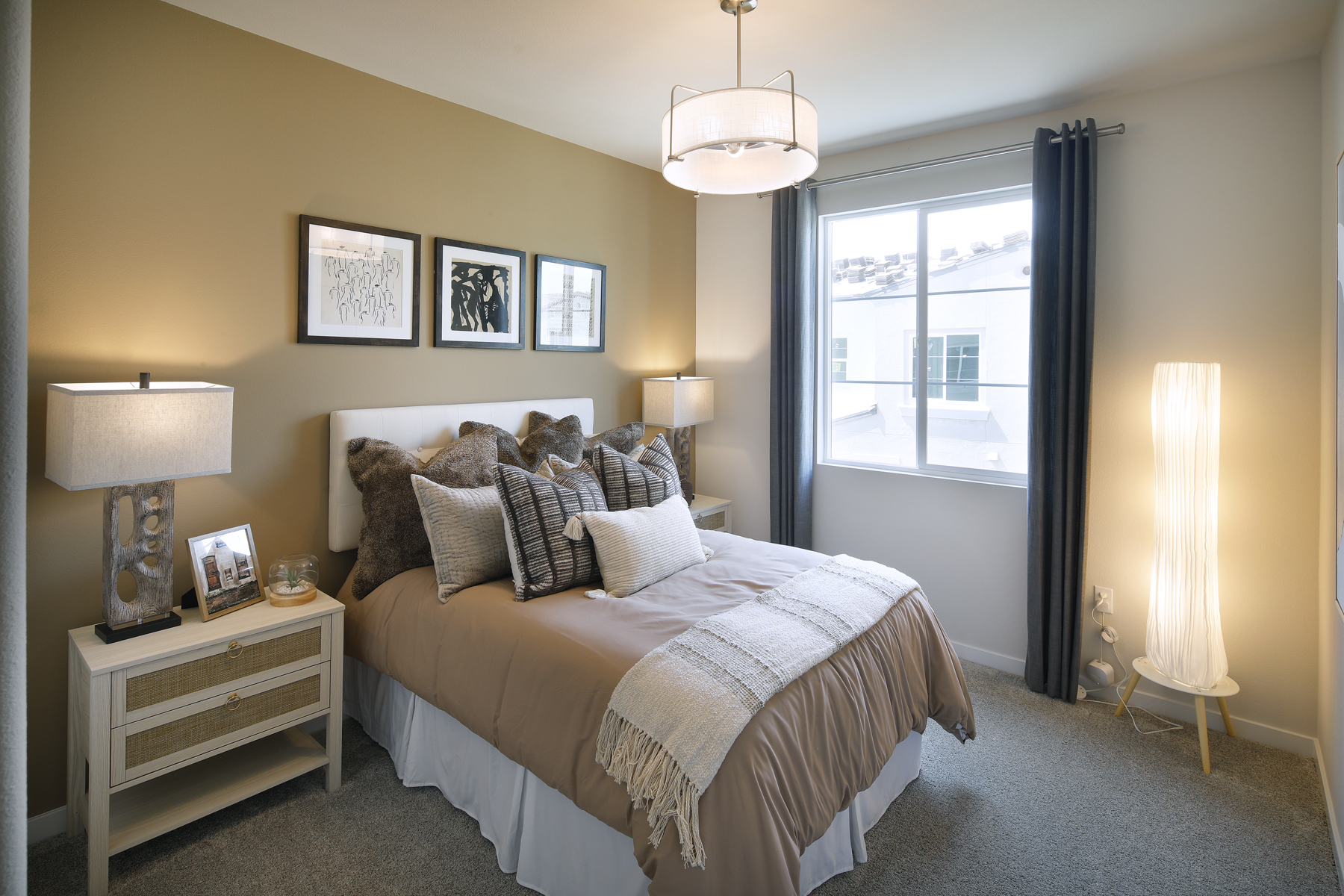 A bedroom with a large window.