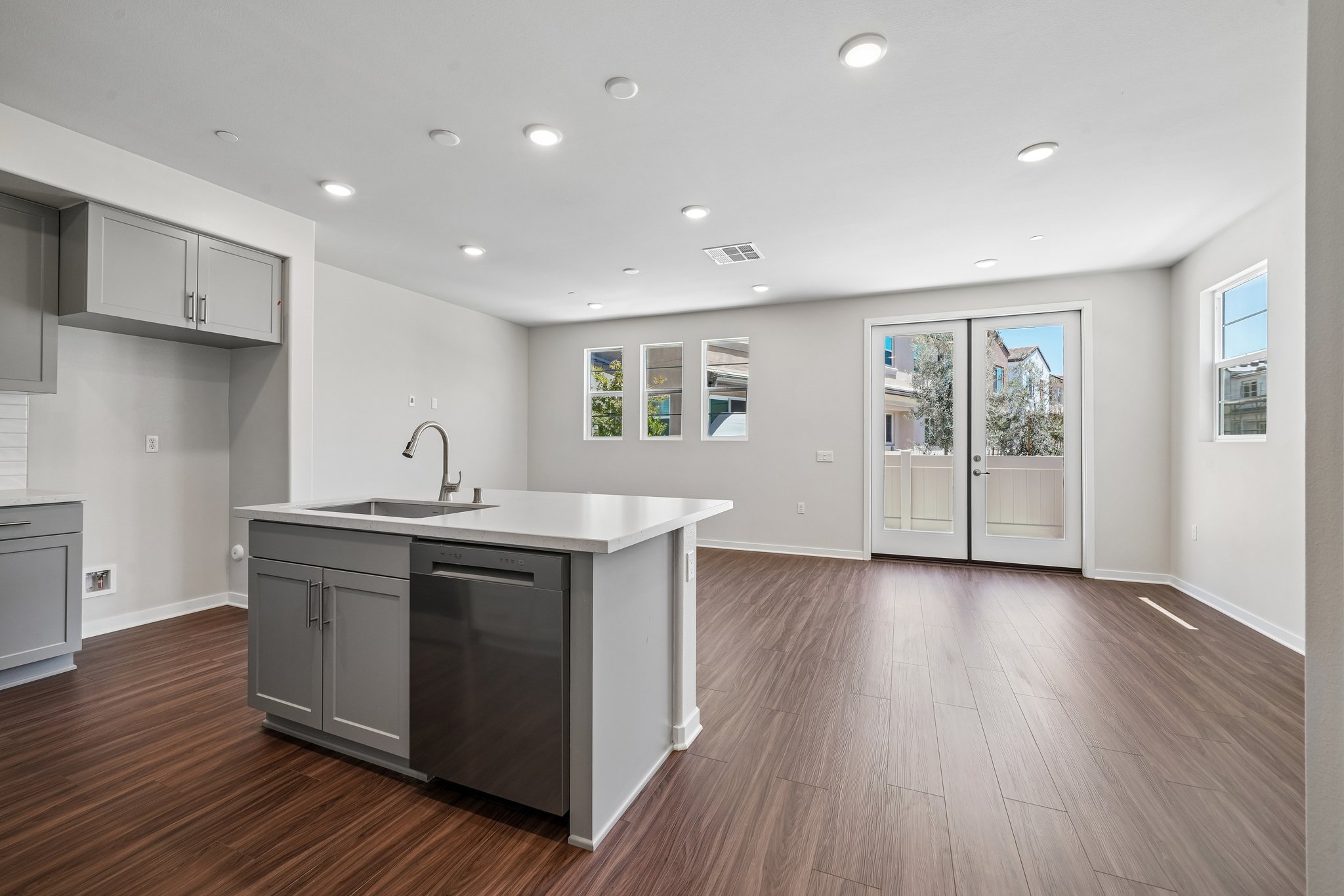 A kitchen with white cabinets.