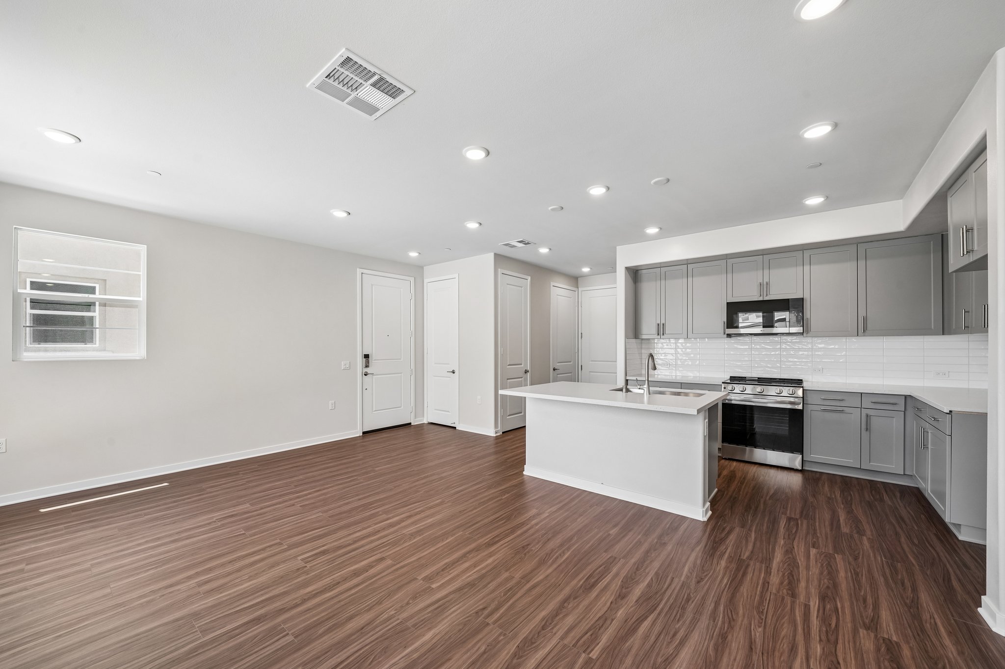 A kitchen with white cabinets.