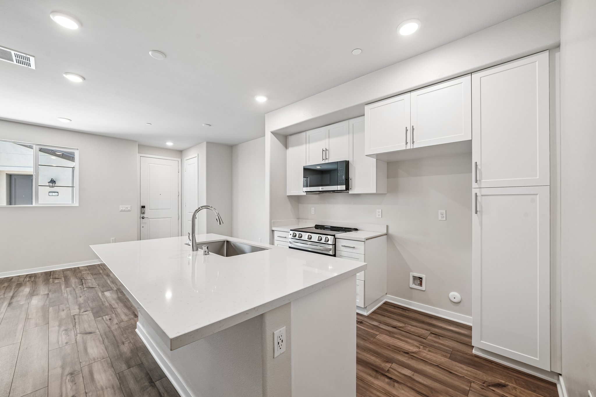 A kitchen with white cabinets.