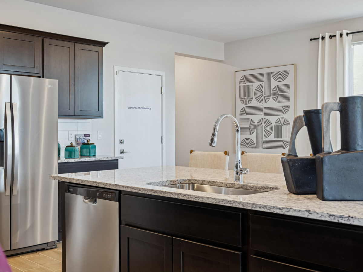 A kitchen with black cabinets.