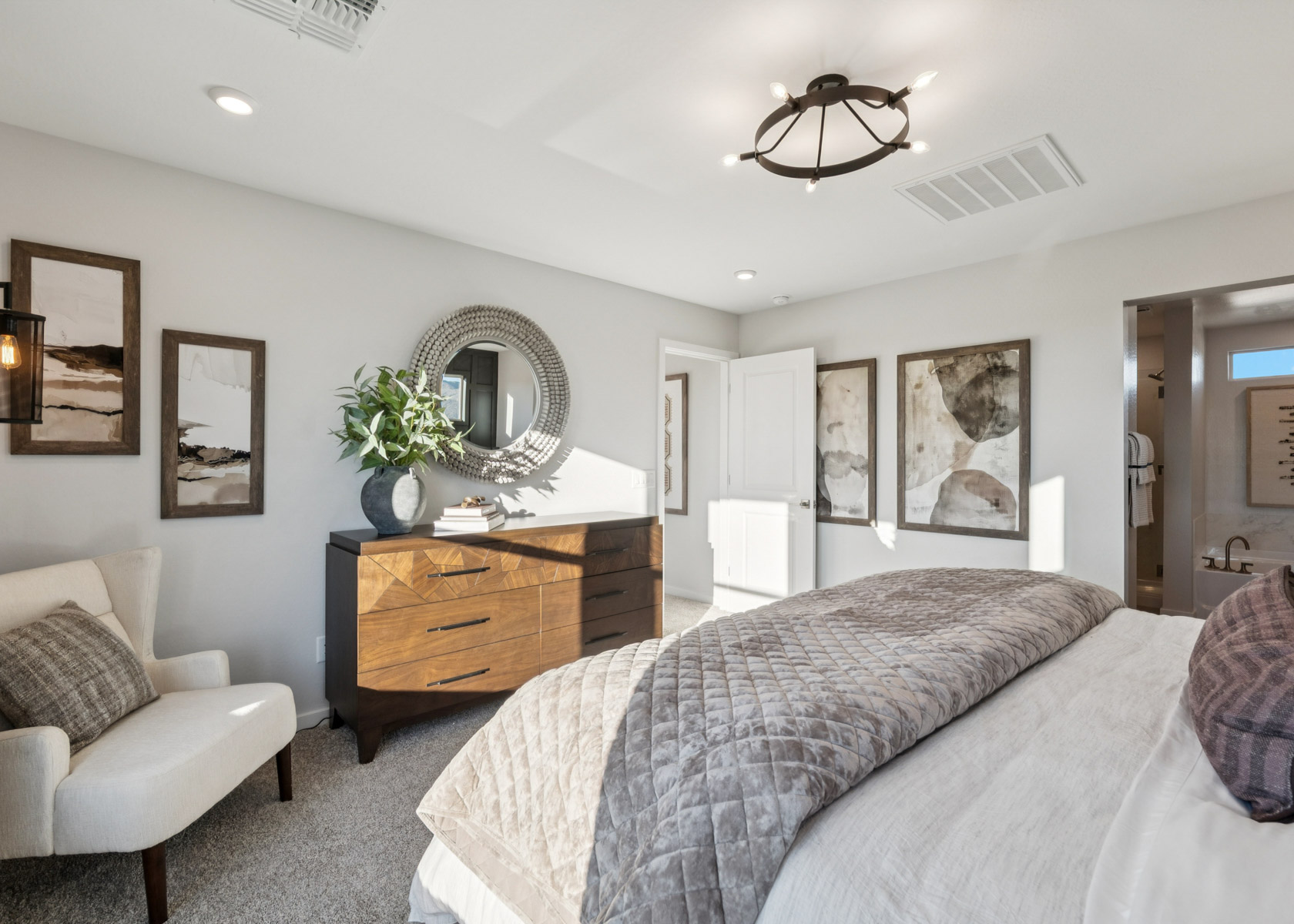 A bedroom with a bed and a dresser.