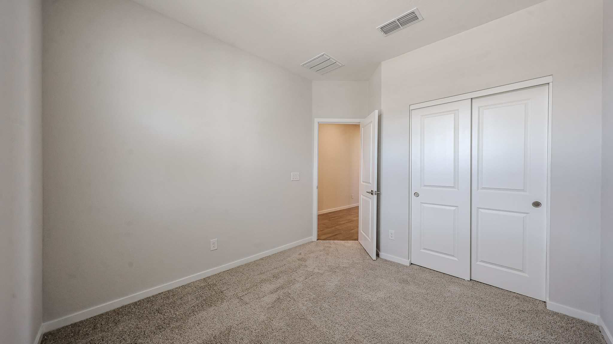 A hallway with white doors.