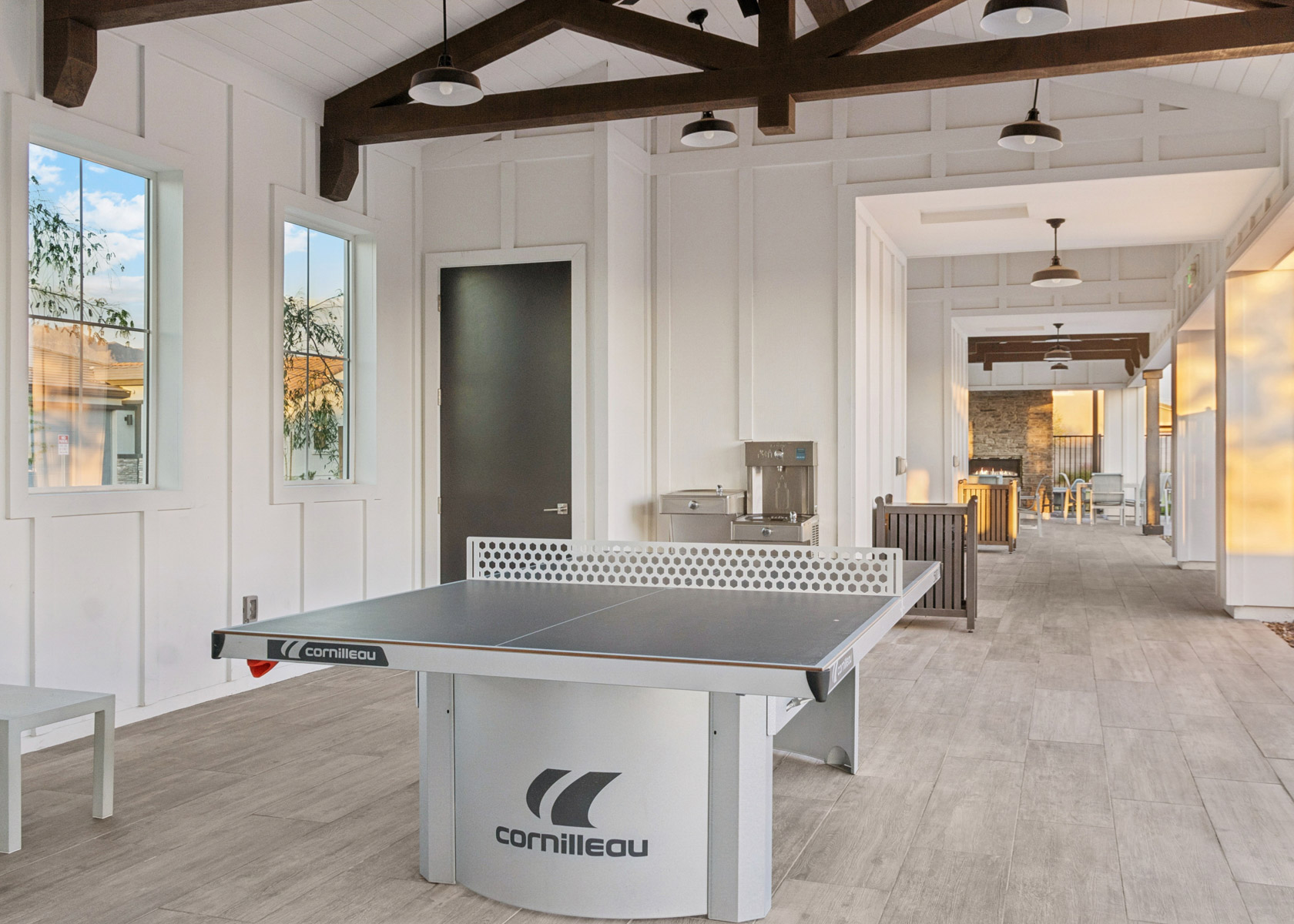 A room with a pool table and a large window.