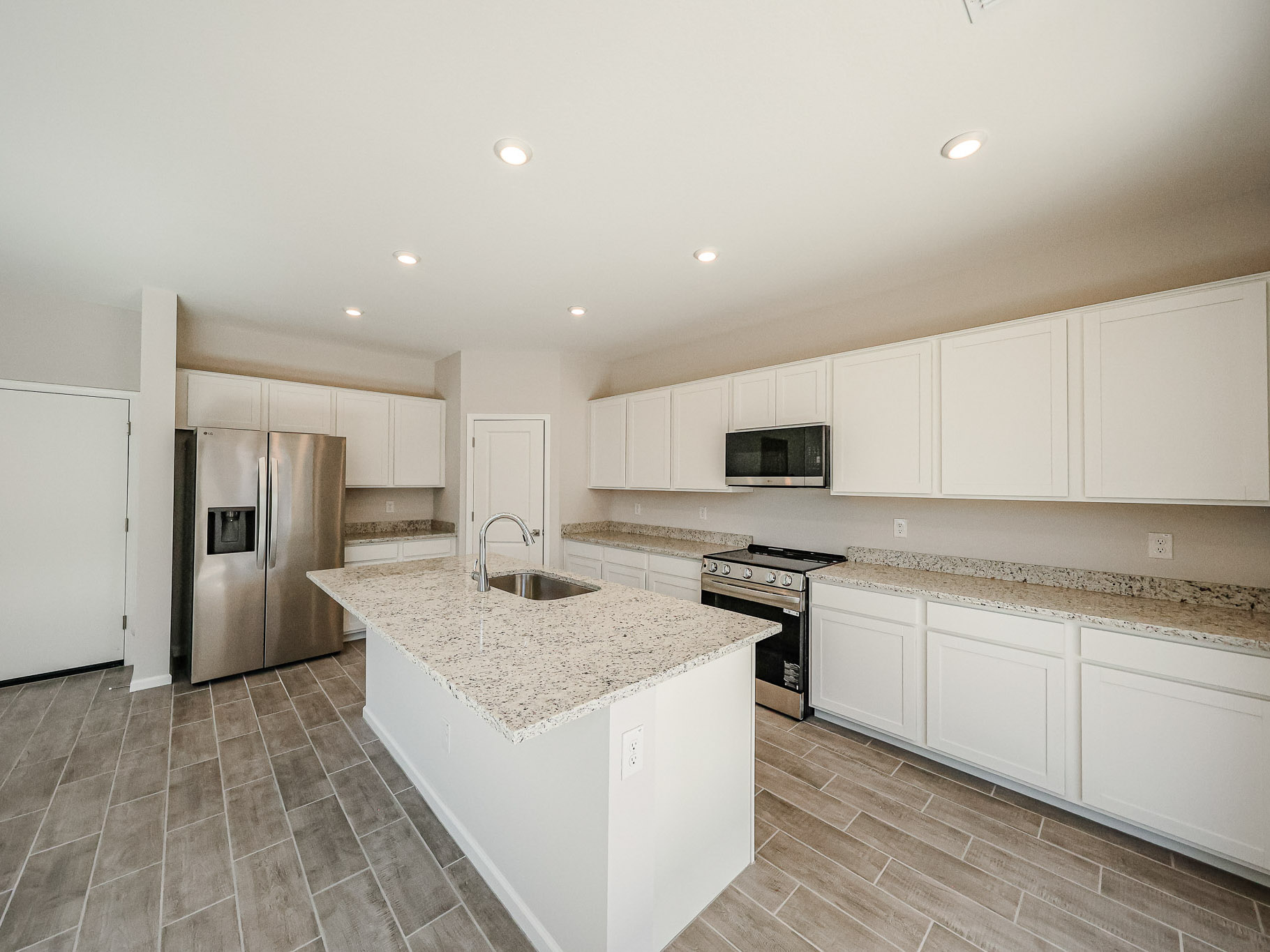 A kitchen with white cabinets.