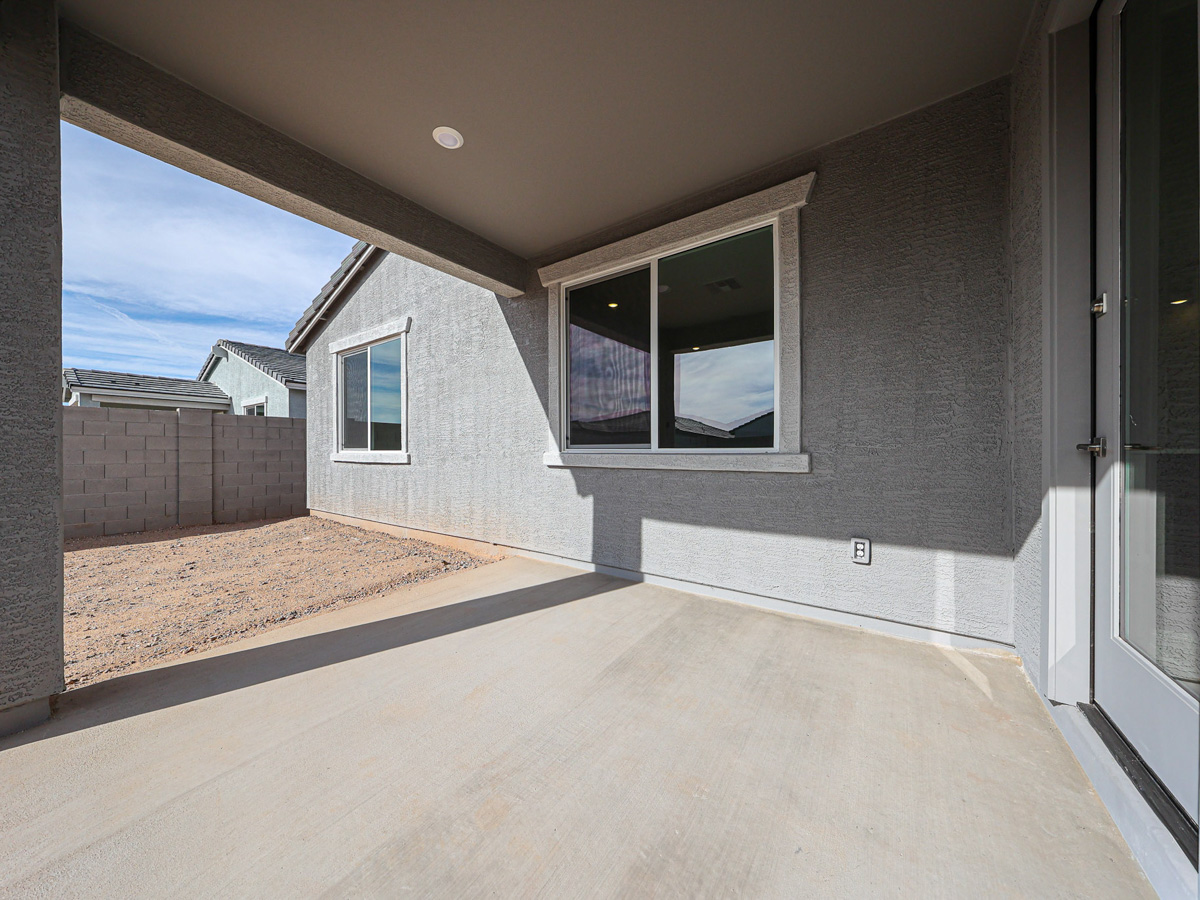 A room with a wood floor and a window with a rug in it.