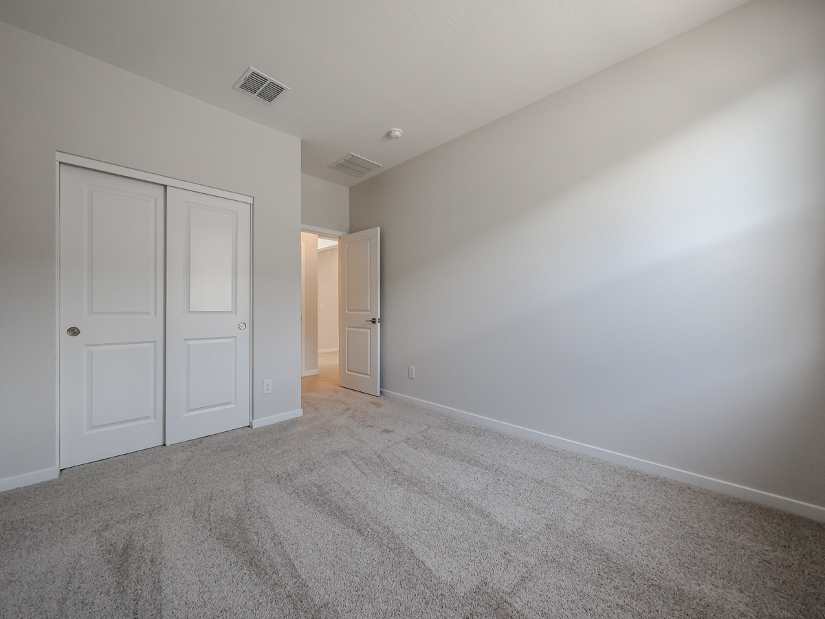 A hallway with white doors.