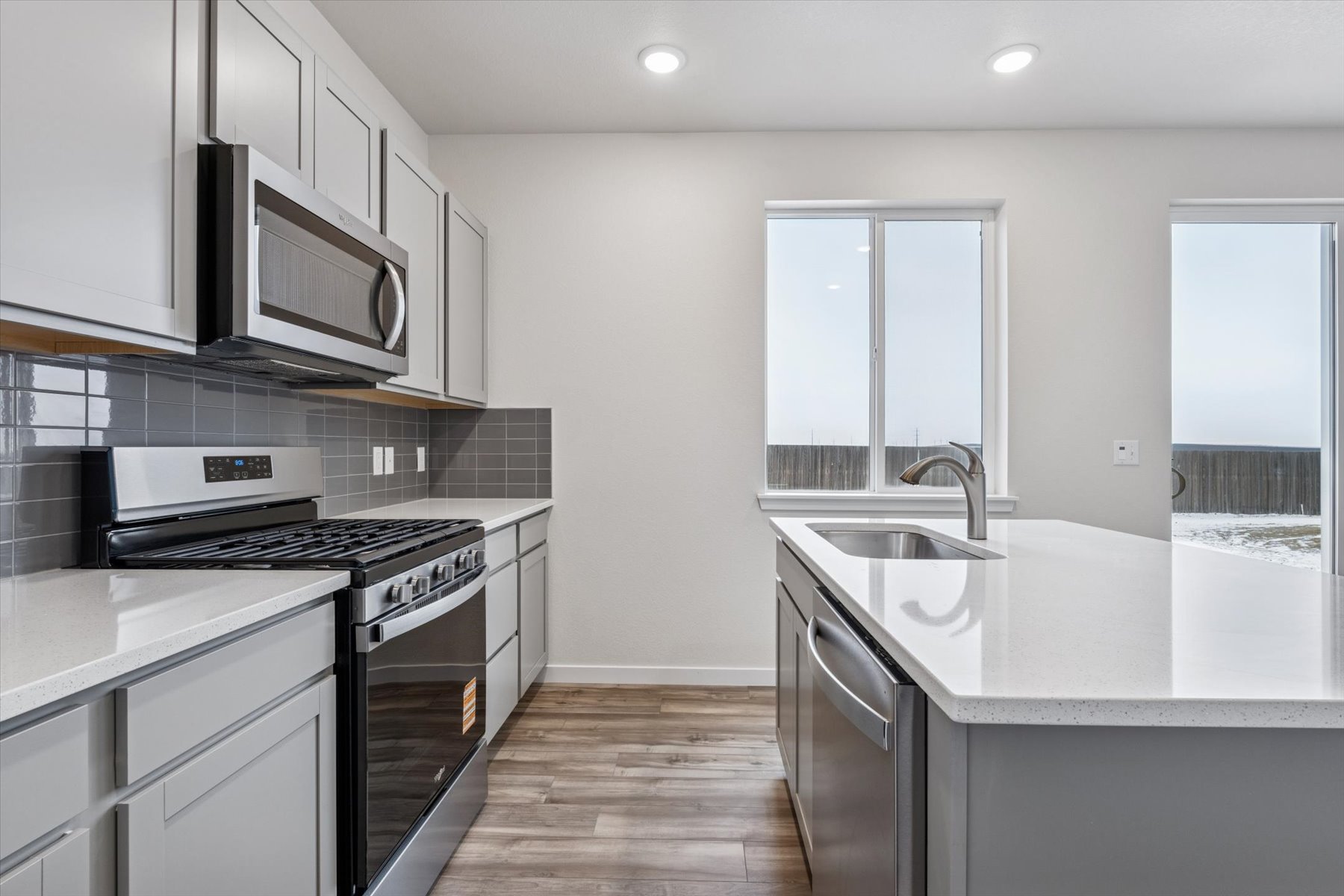 A kitchen with white cabinets.