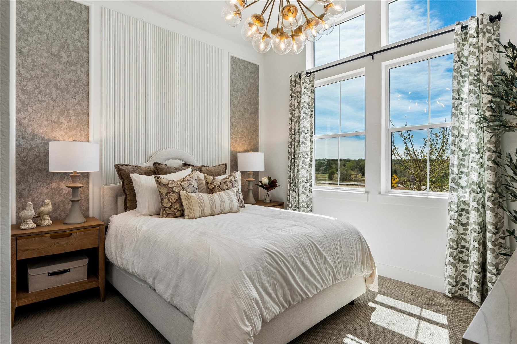 A bedroom with a large window.