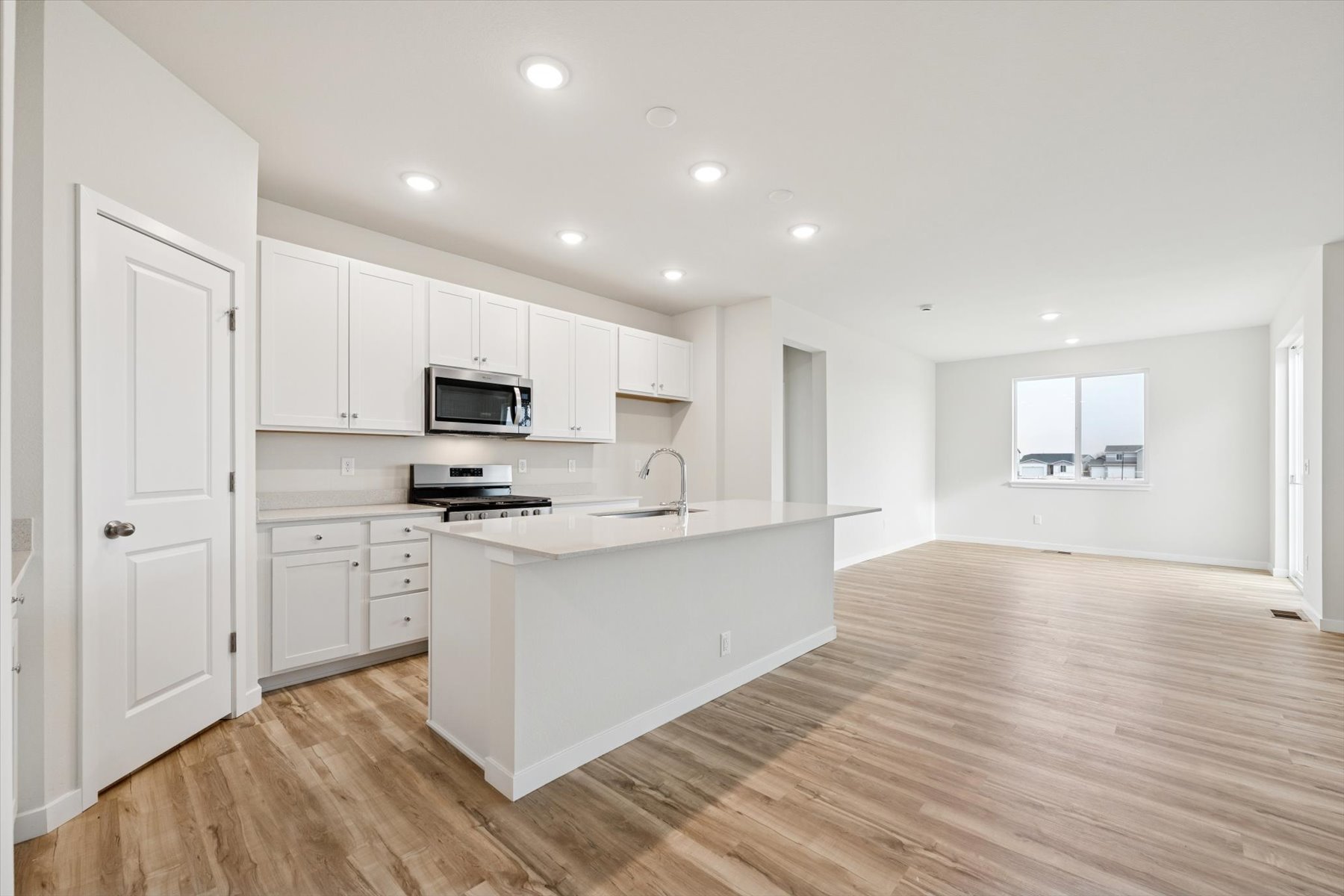 A kitchen with white cabinets.