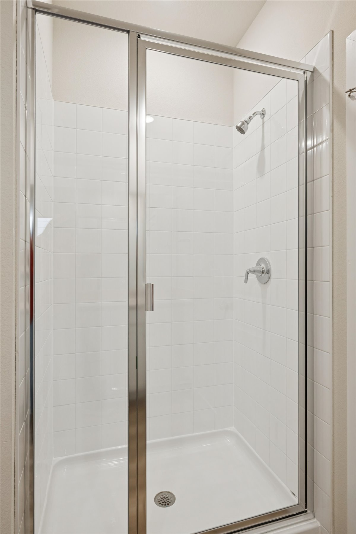 A shower with a glass door.