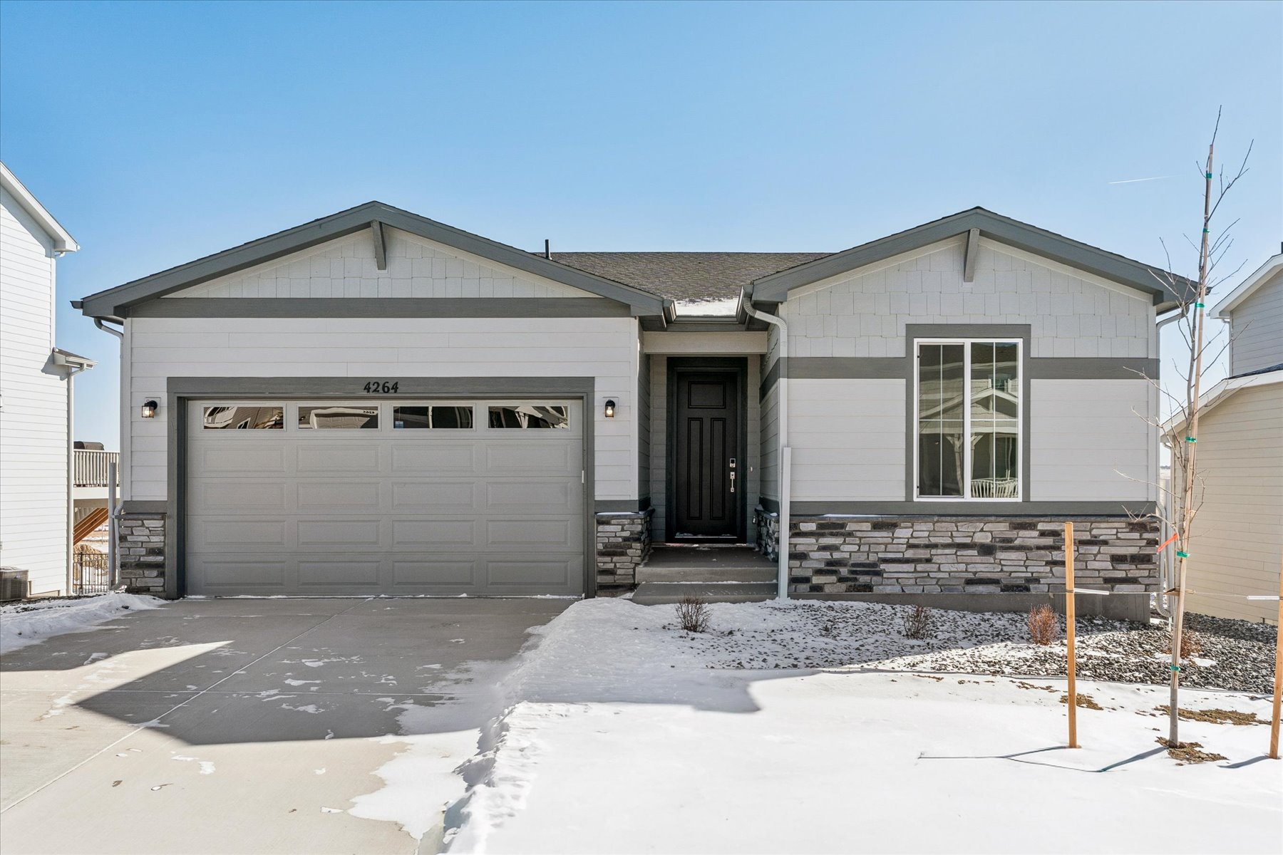 A house with garages and snow.