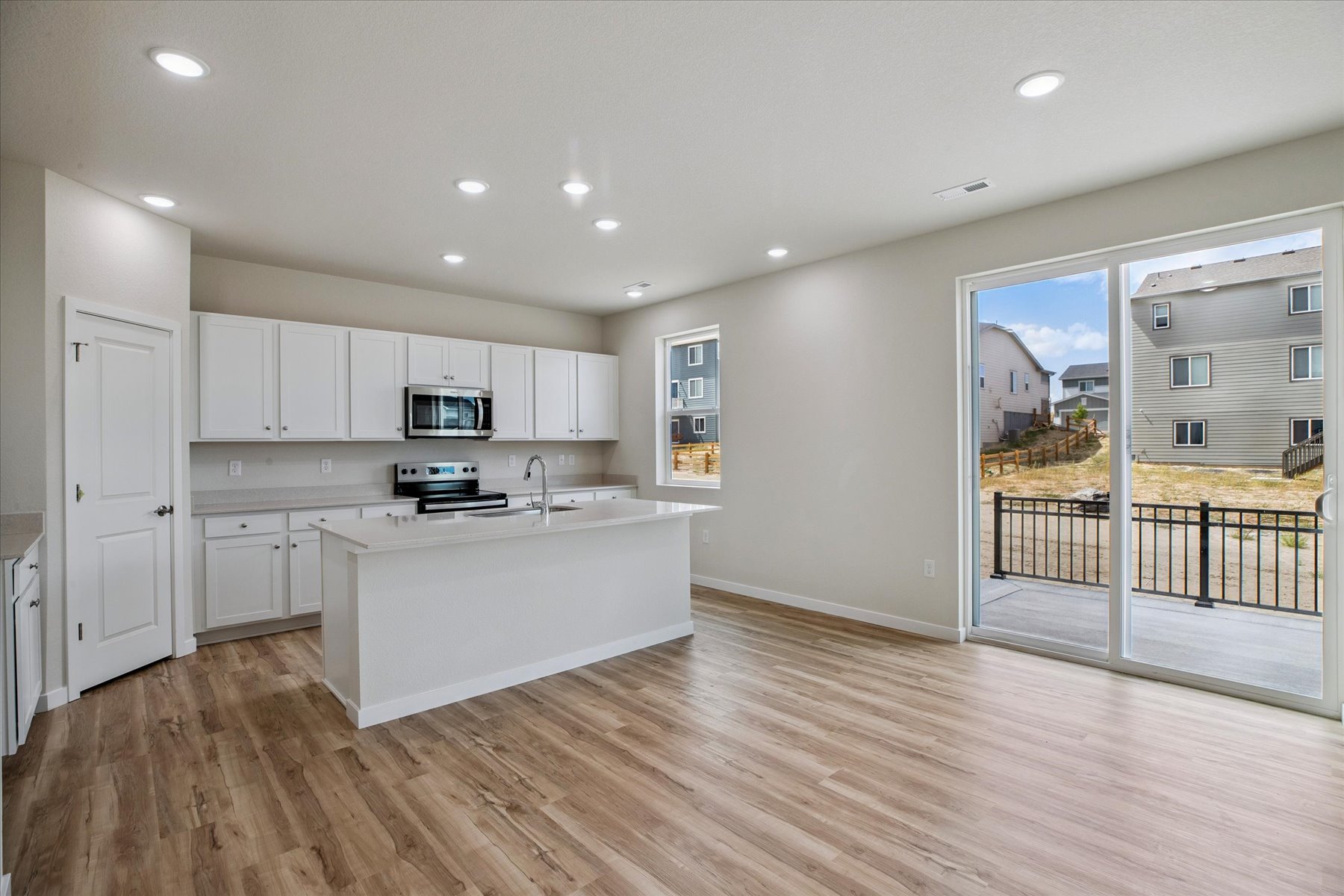 A kitchen with white cabinets.