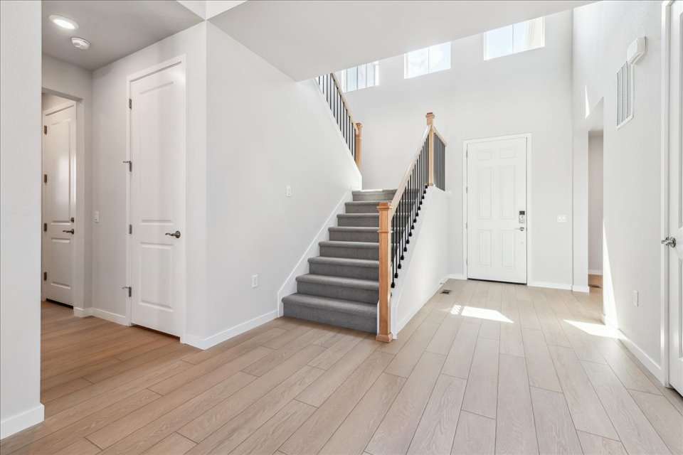 A long hallway with white doors.