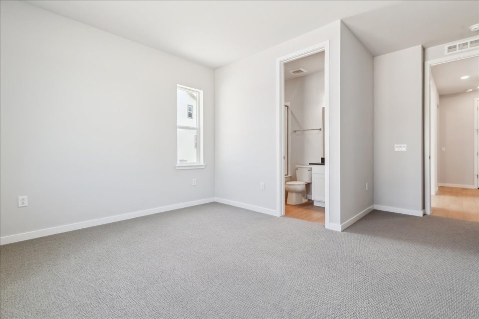 A room with a toilet and a sink.