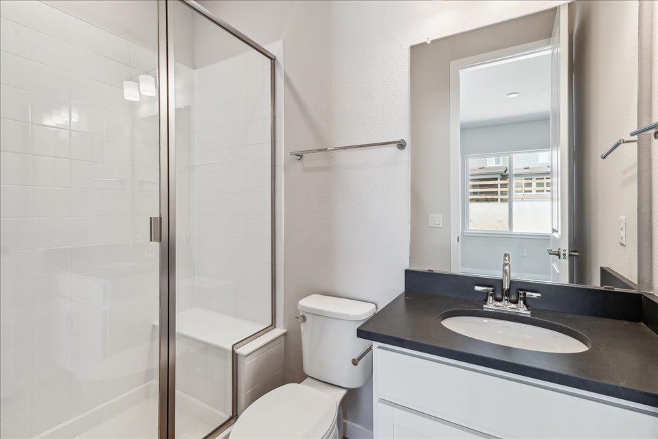 A bathroom with a sink toilet and shower.