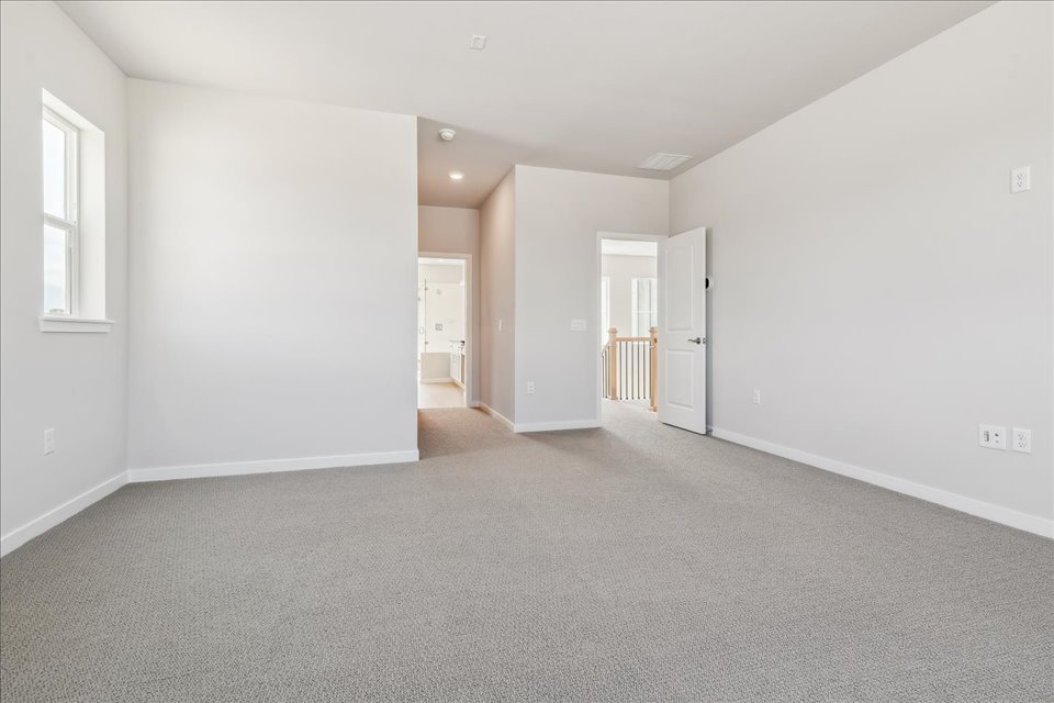 A long hallway with white walls.