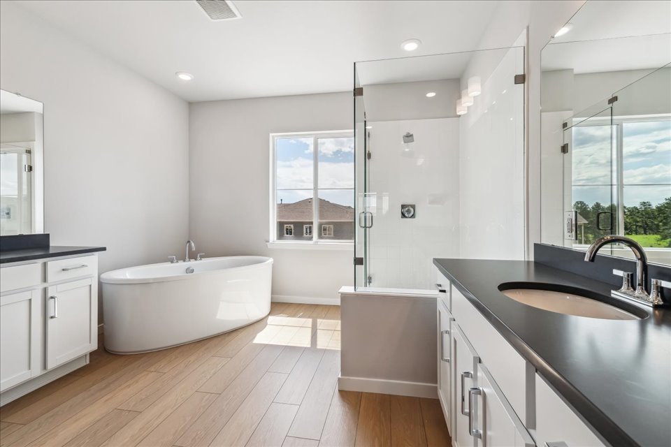A bathroom with a tub sink and a bathtub.