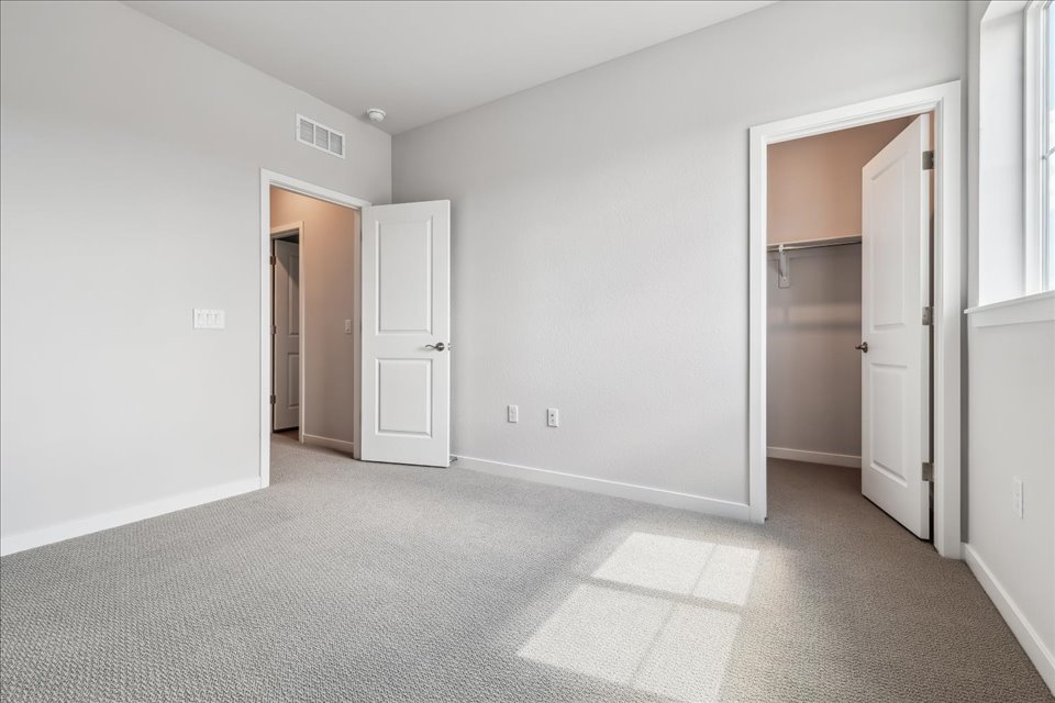 A hallway with white doors.