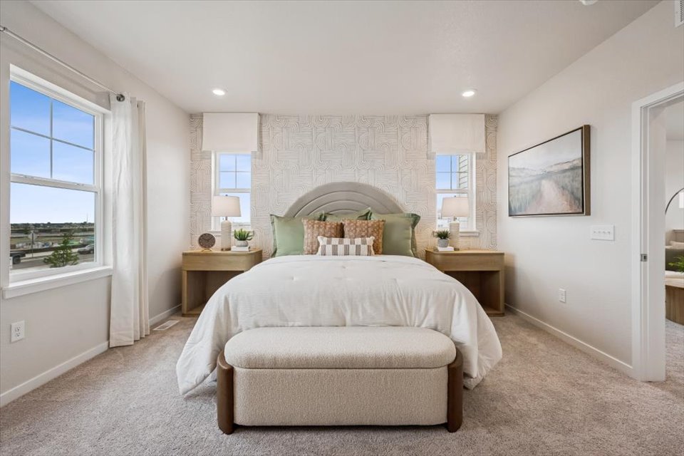 A bedroom with a bed and a couch.