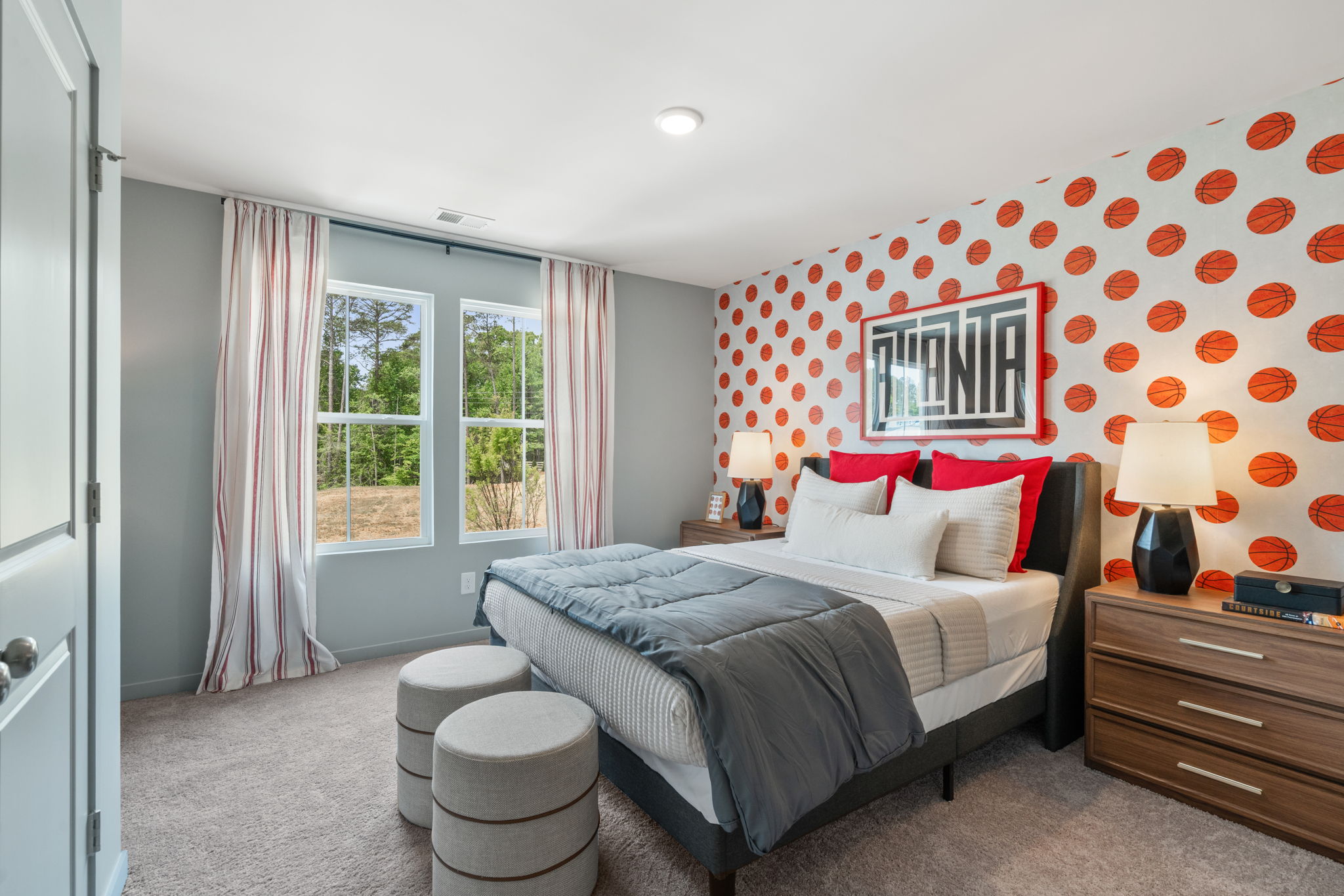 A bedroom with a bed and a window.