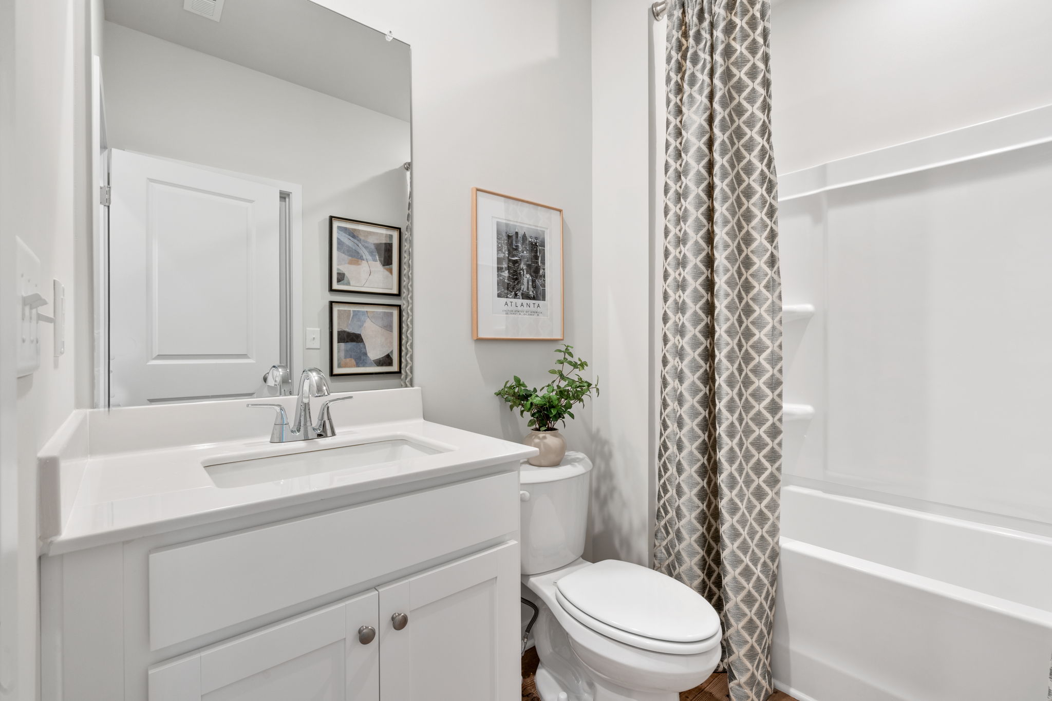 A bathroom with a shower curtain.