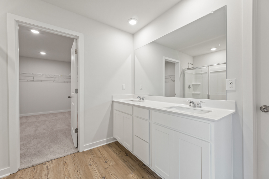 A bathroom with a large mirror.