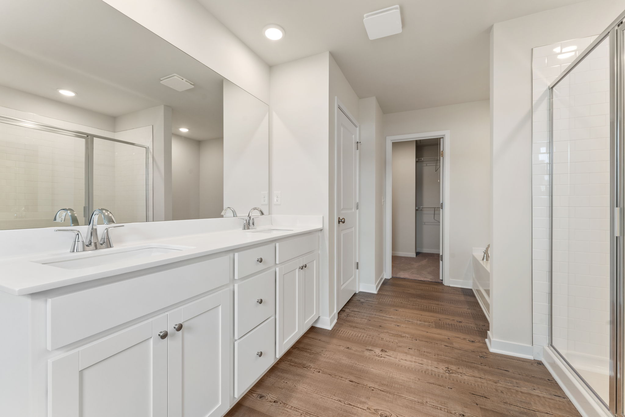 A bathroom with white cabinets.