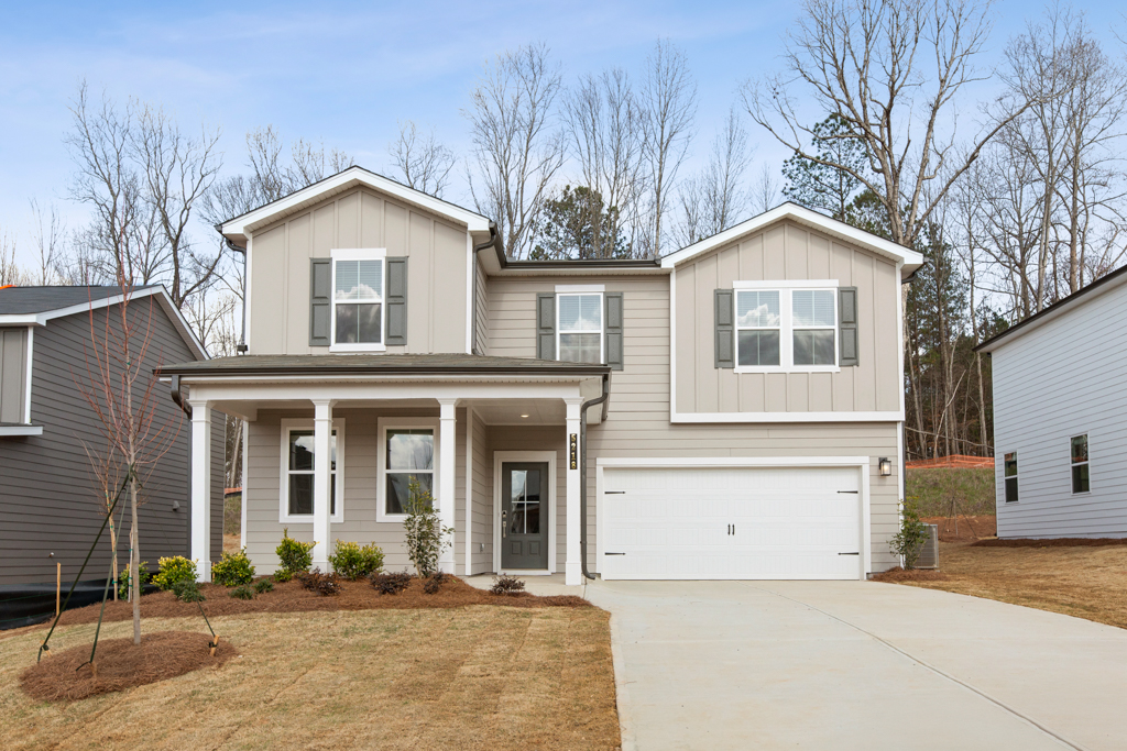 A white house with a garage.